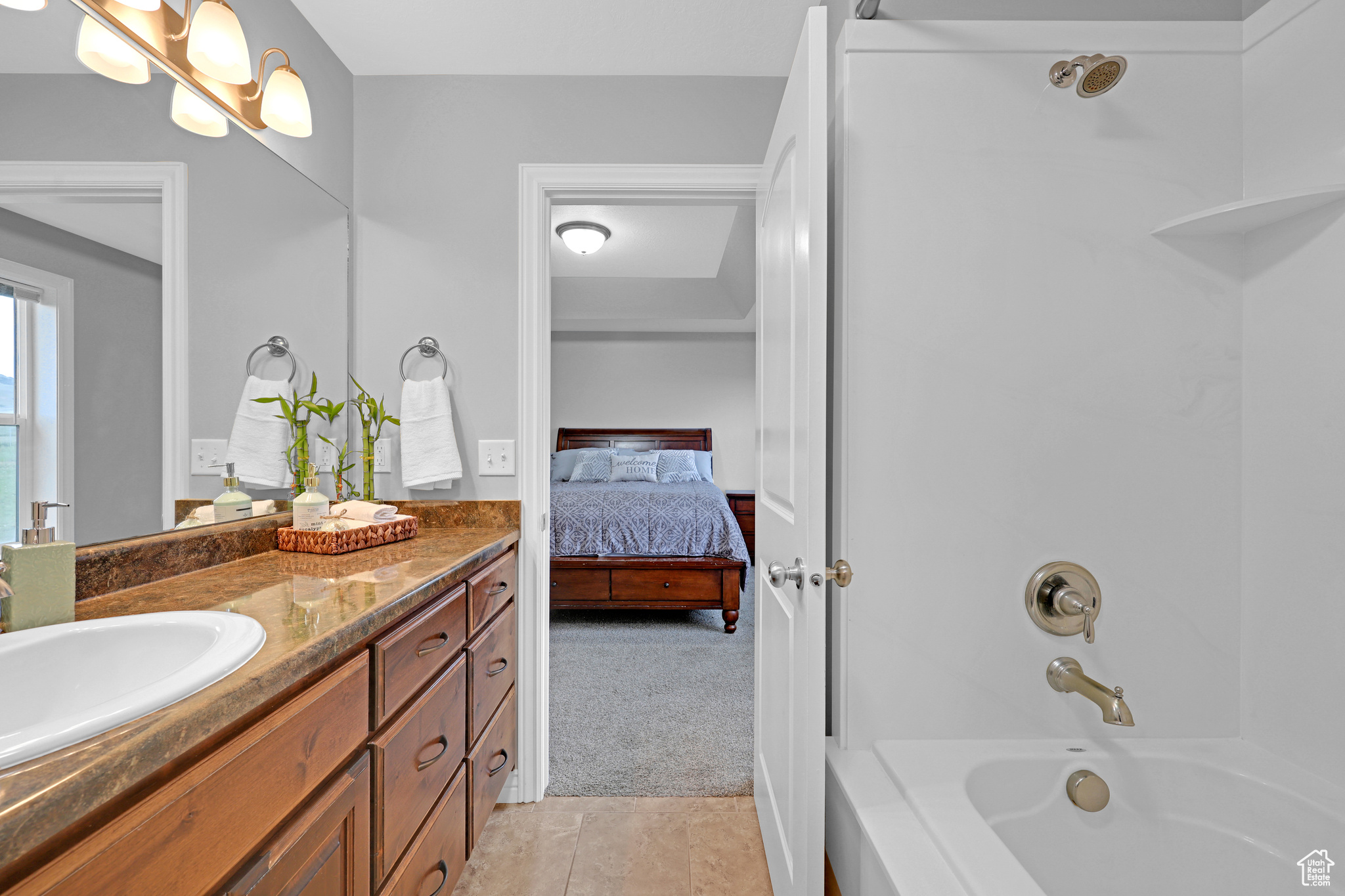 Bathroom with shower / bathtub combination, tile patterned flooring, and vanity