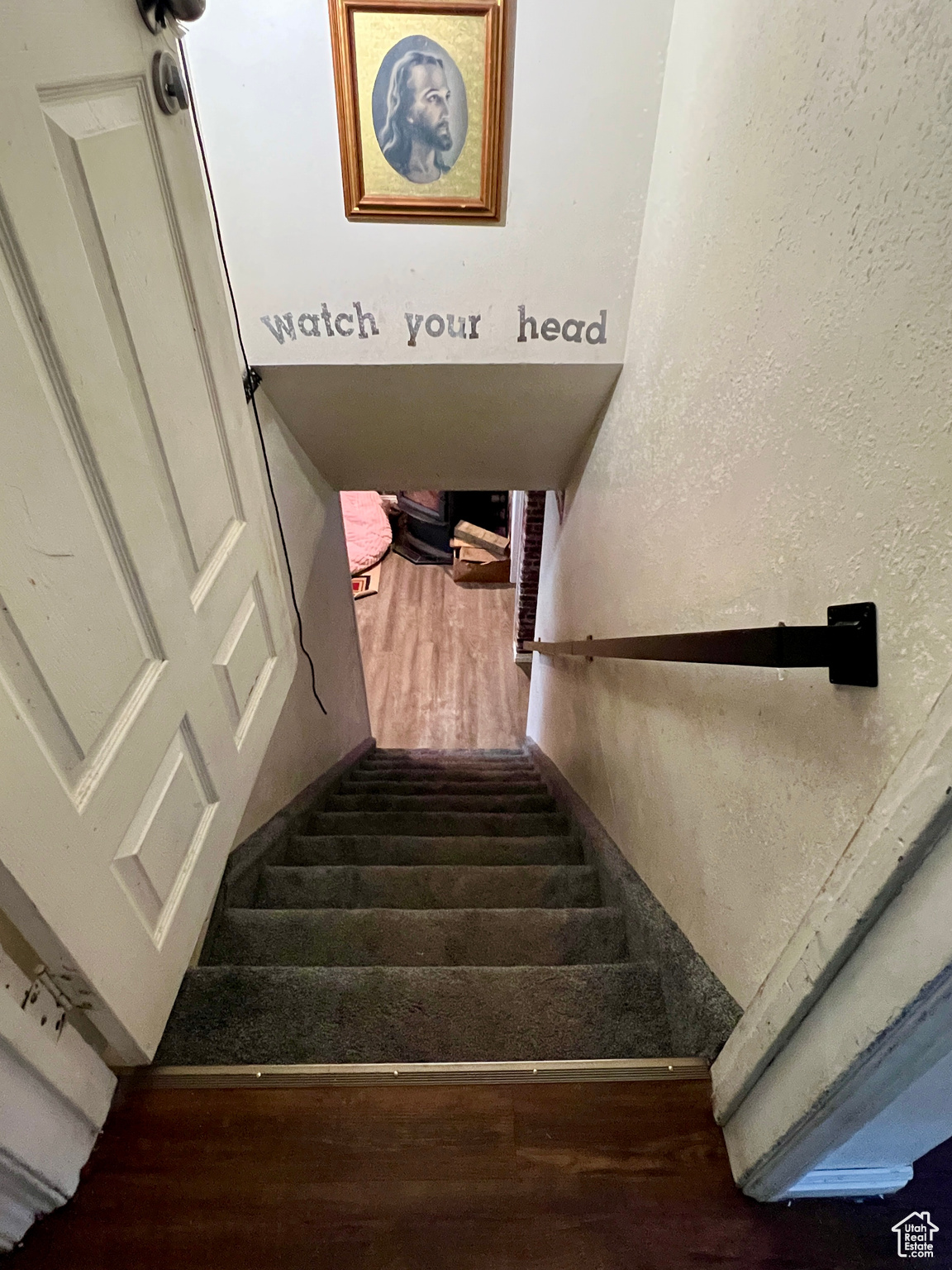 Stairs featuring hardwood / wood-style flooring