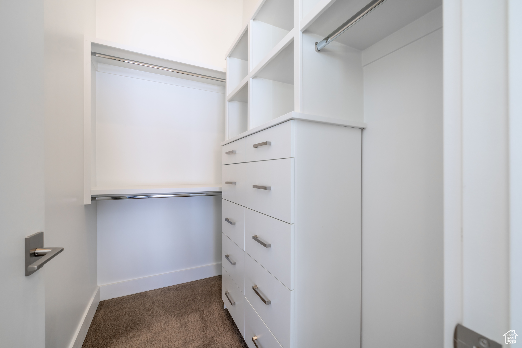 Walk in closet featuring dark colored carpet