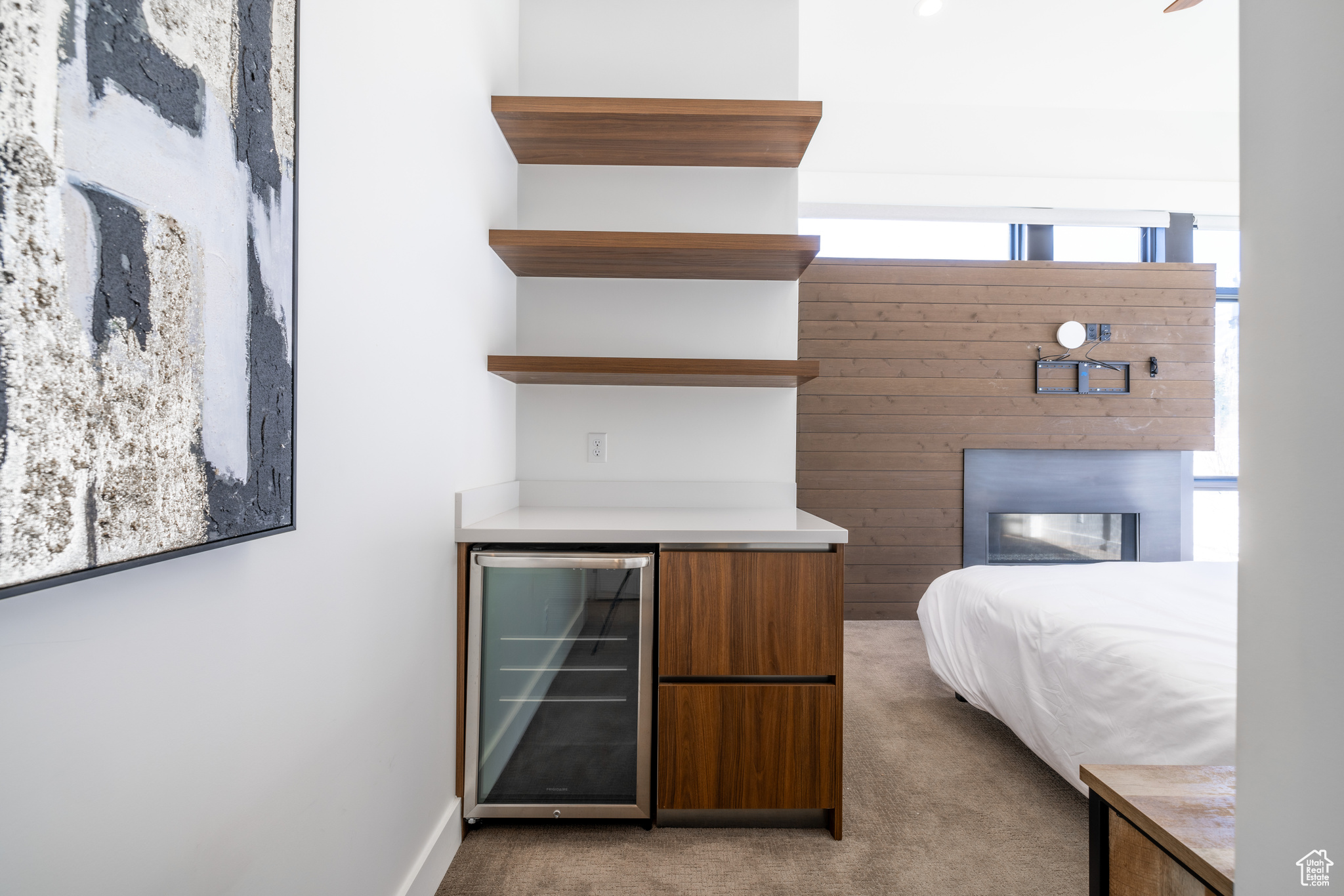 Carpeted bedroom featuring wine cooler