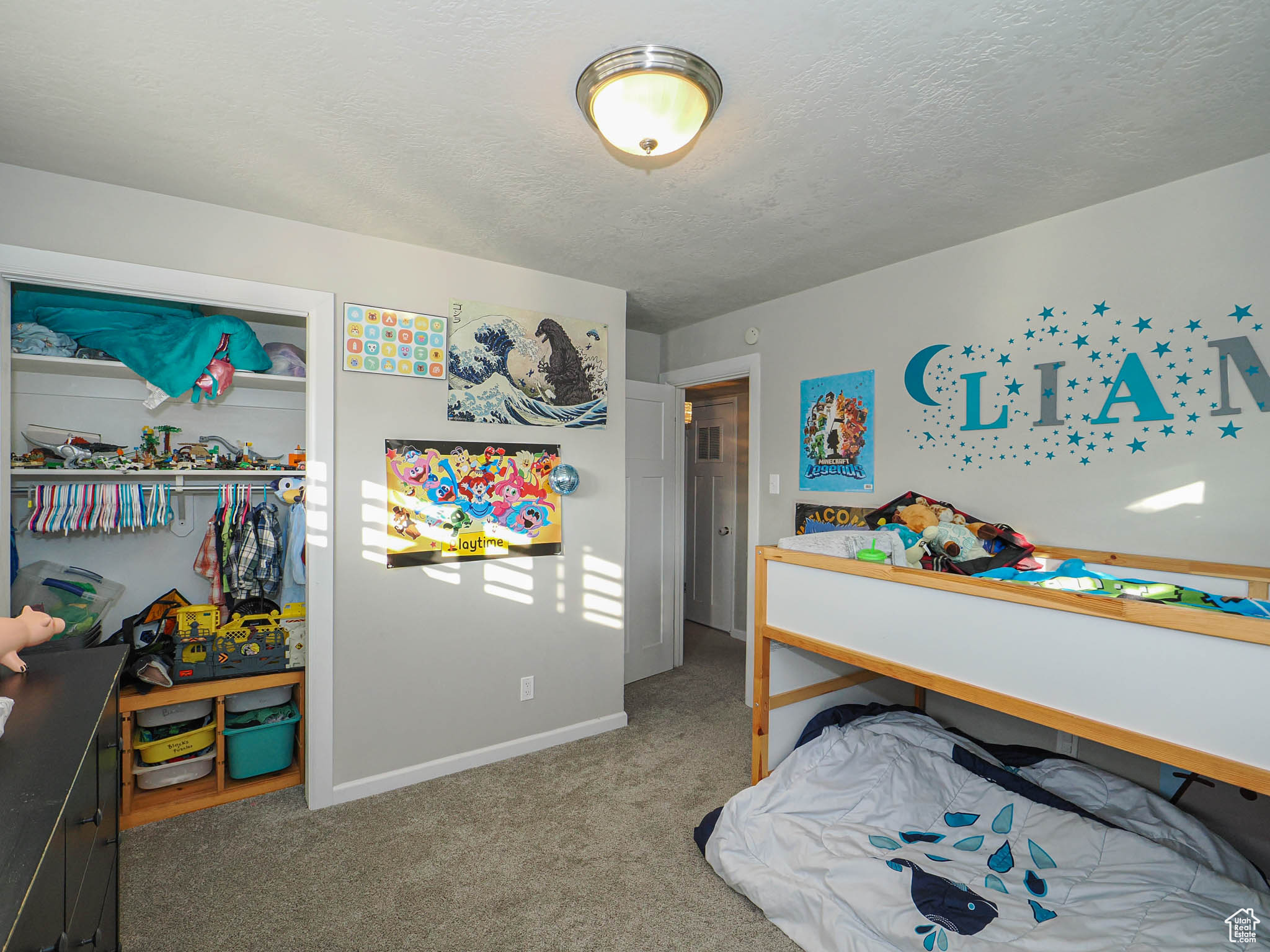 Bedroom with a textured ceiling and carpet flooring