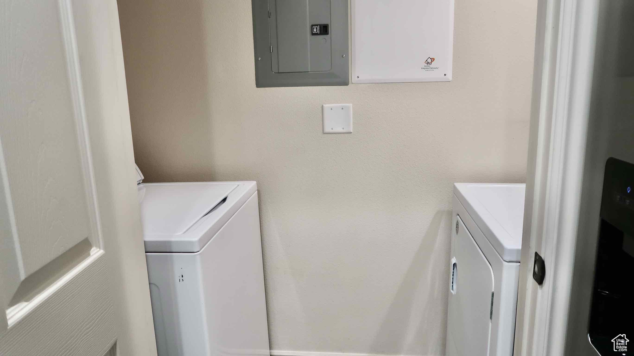 Washroom with electric panel and washer and dryer