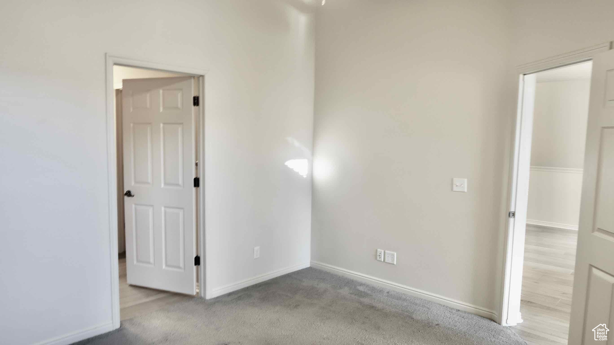 Empty room with light colored carpet