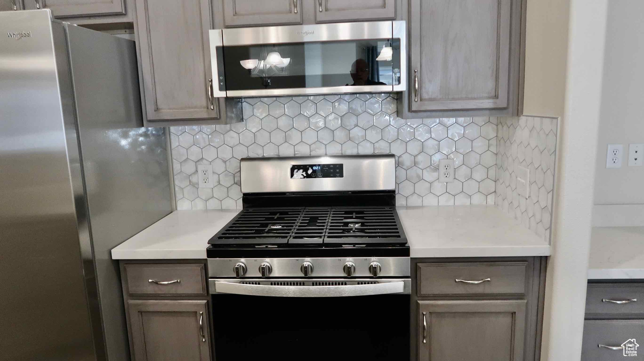 Kitchen featuring backsplash and stainless steel appliances