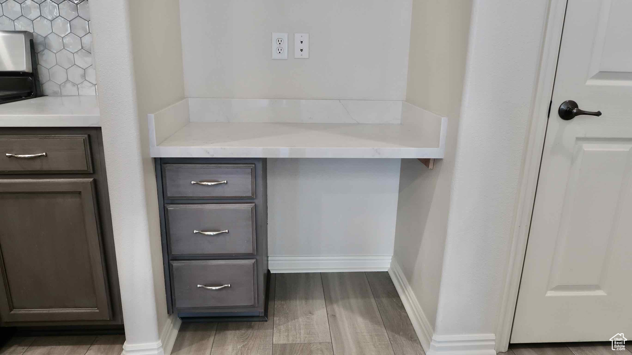 Room details featuring hardwood / wood-style flooring and tasteful backsplash