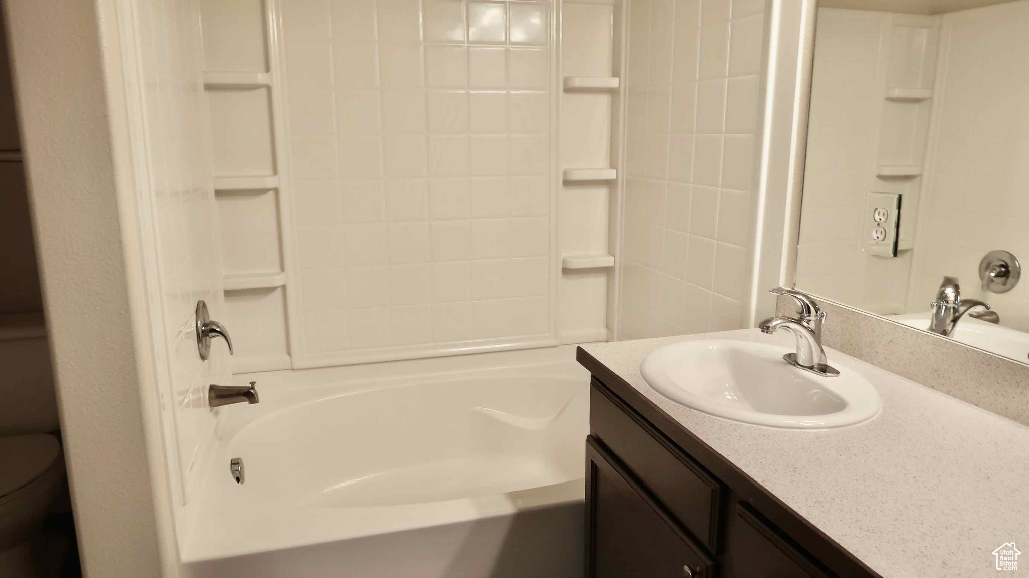 Full bathroom featuring shower / tub combination, vanity, and toilet