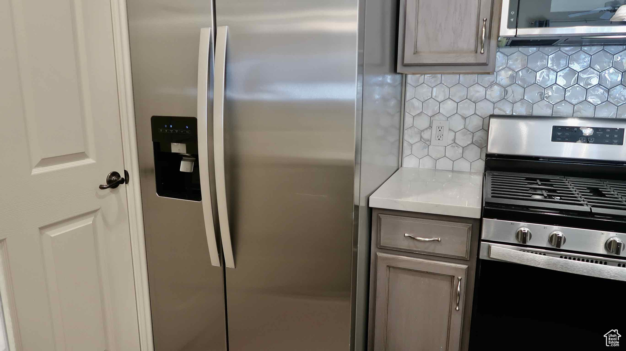 Kitchen with backsplash and stainless steel appliances