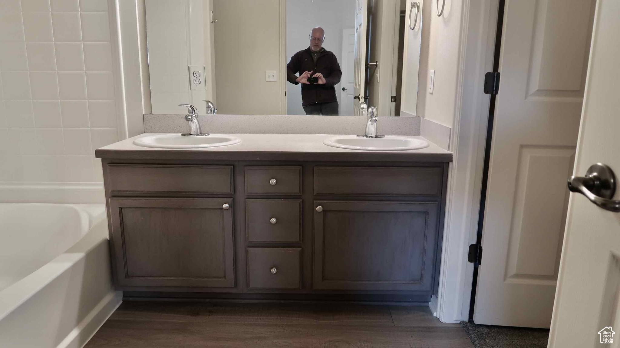 Bathroom with hardwood / wood-style floors and vanity