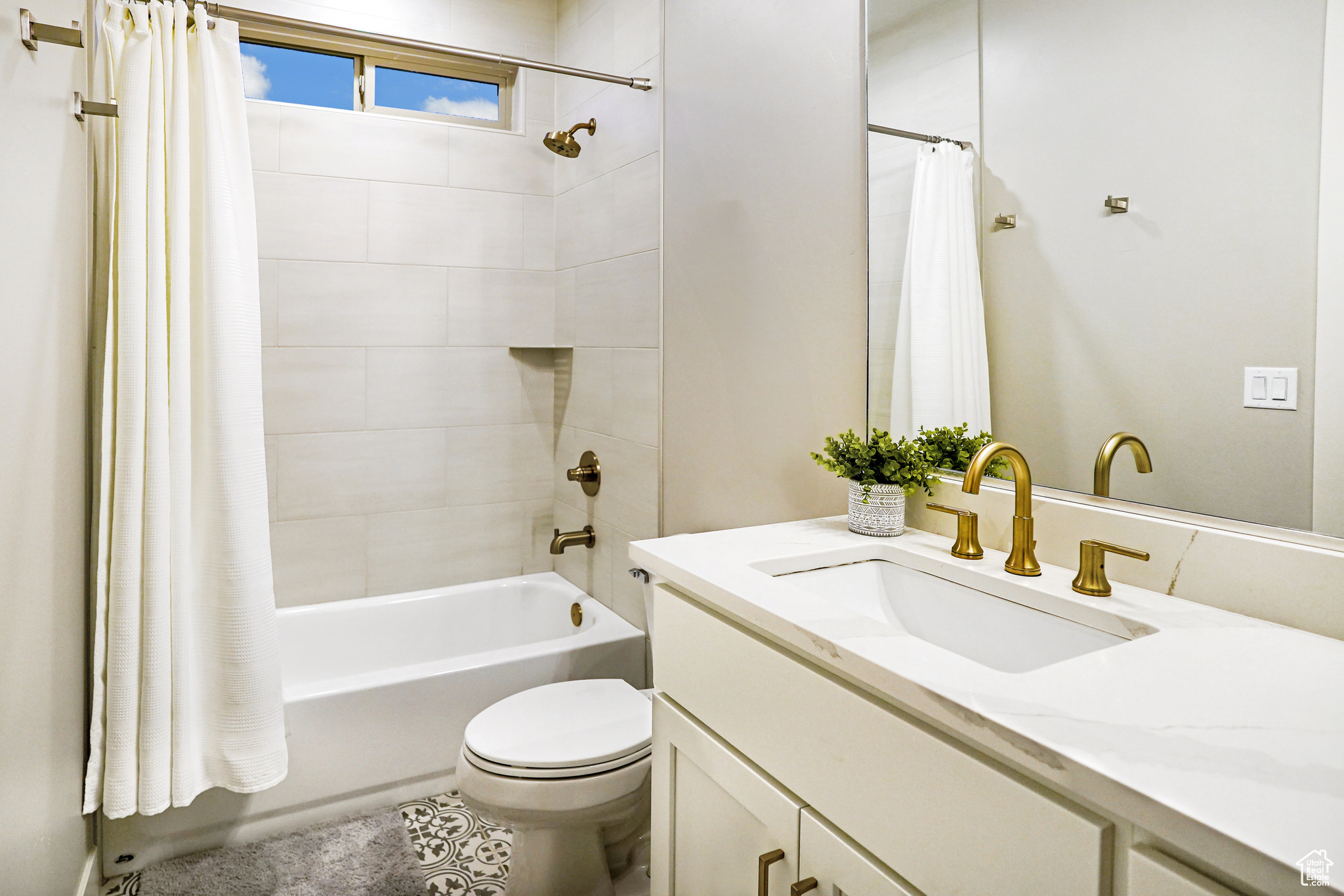 The 'ensuite' bath includes quartz counters, elegant fixtures, and a grand feel with it's floor to ceiling tiled shower bath combo.