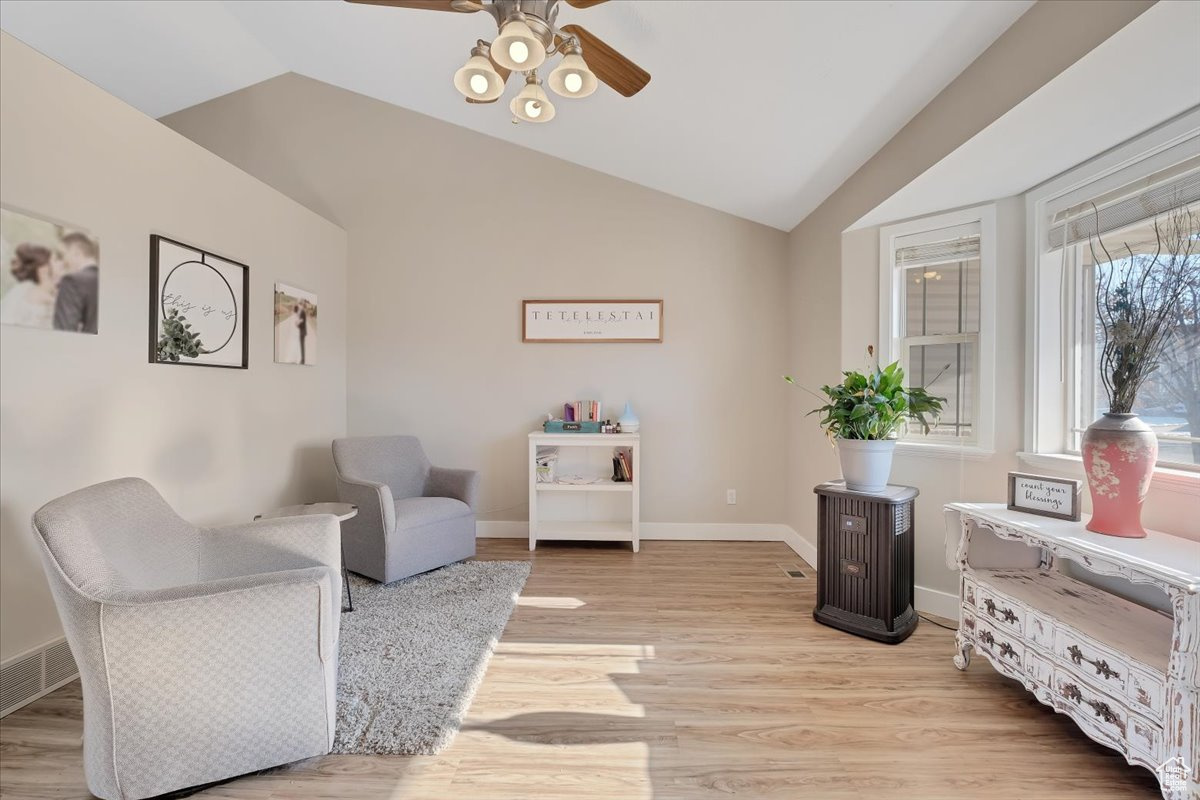 Sitting room with ceiling fan, light hardwood / wood-style flooring, and vaulted ceiling