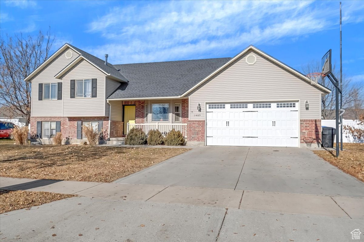 Split level home with covered porch and a garage