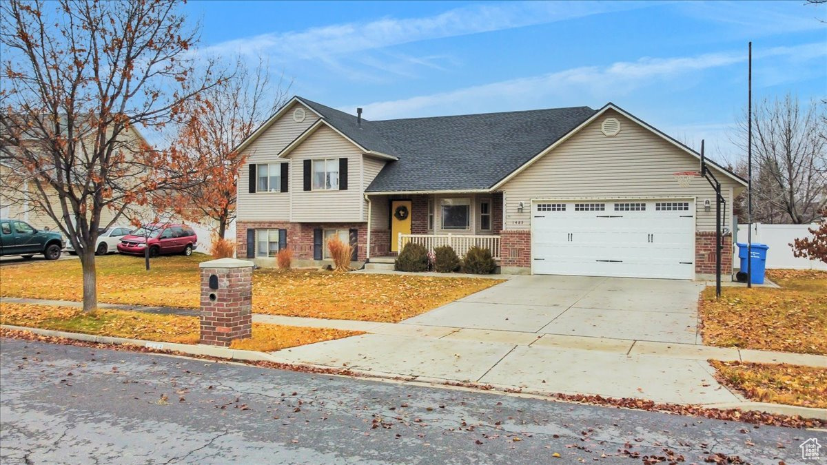 View of front of home with a garage and a porch