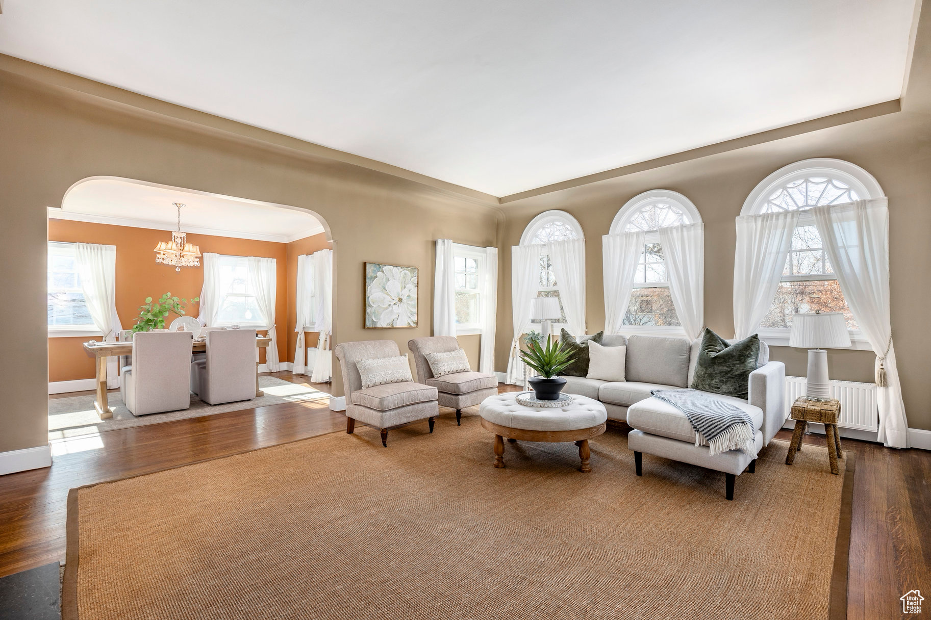 Living room with radiator, an inviting chandelier, and dark hardwood / wood-style flooring