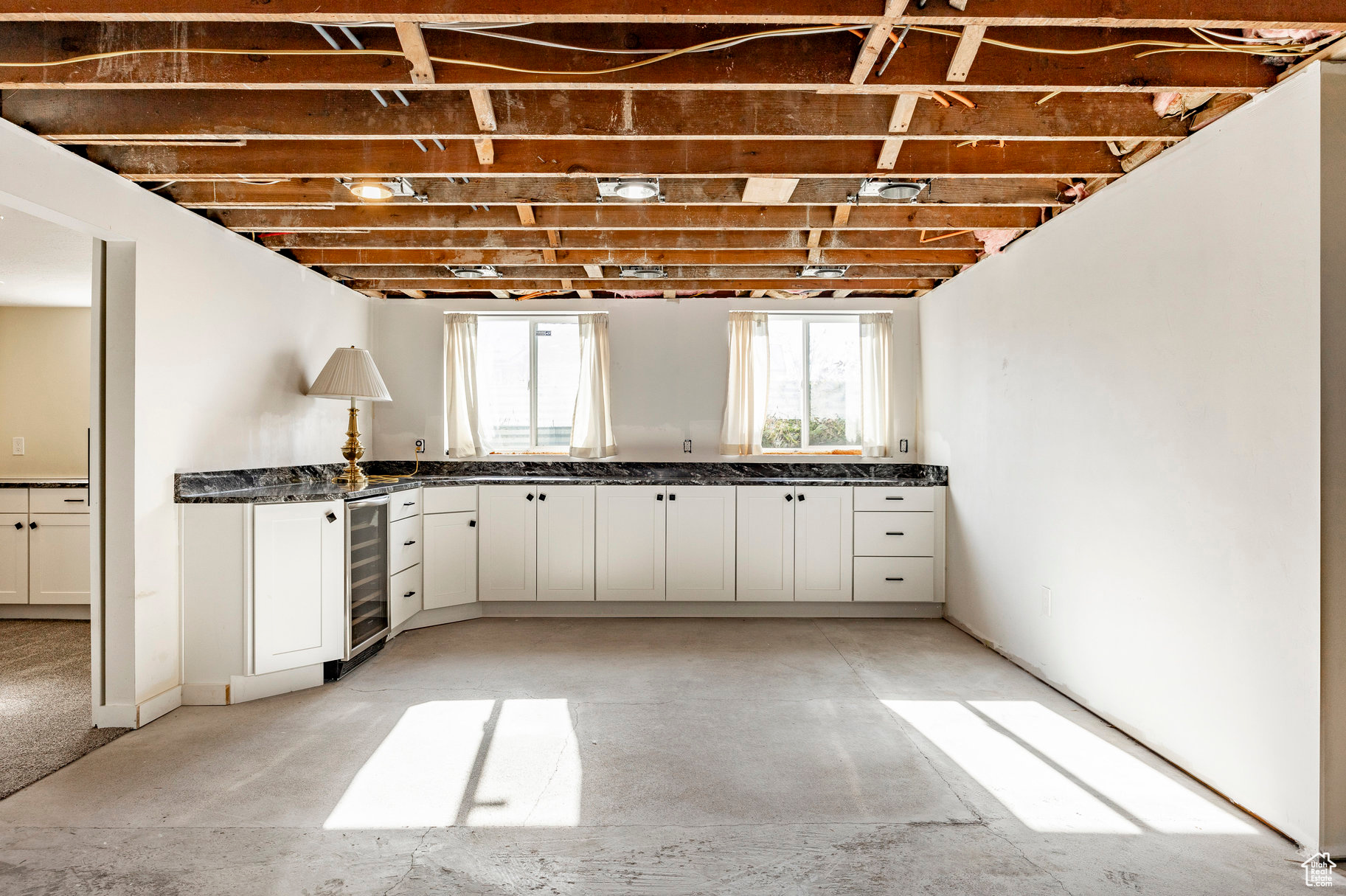 Kitchen with white cabinetry and wine cooler