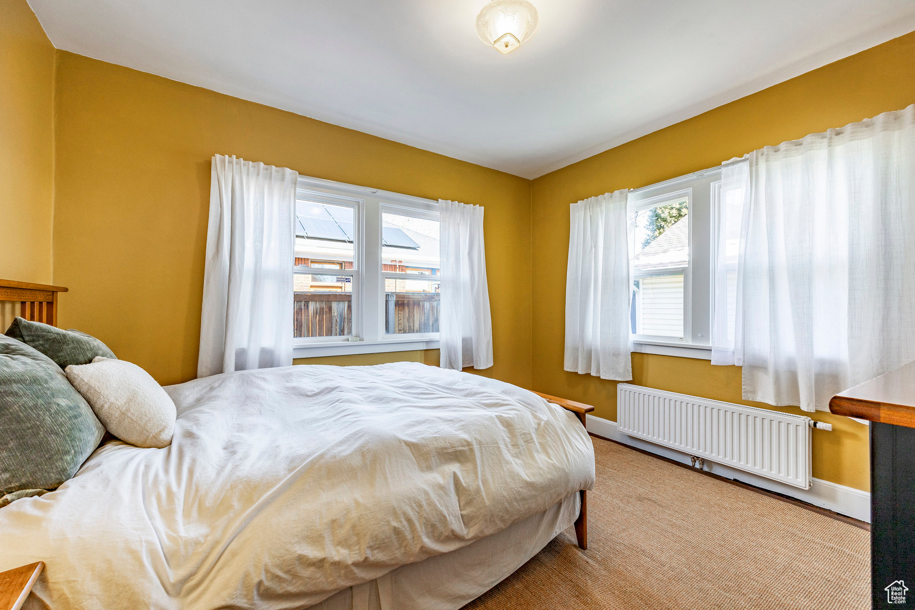 Bedroom with radiator heating unit