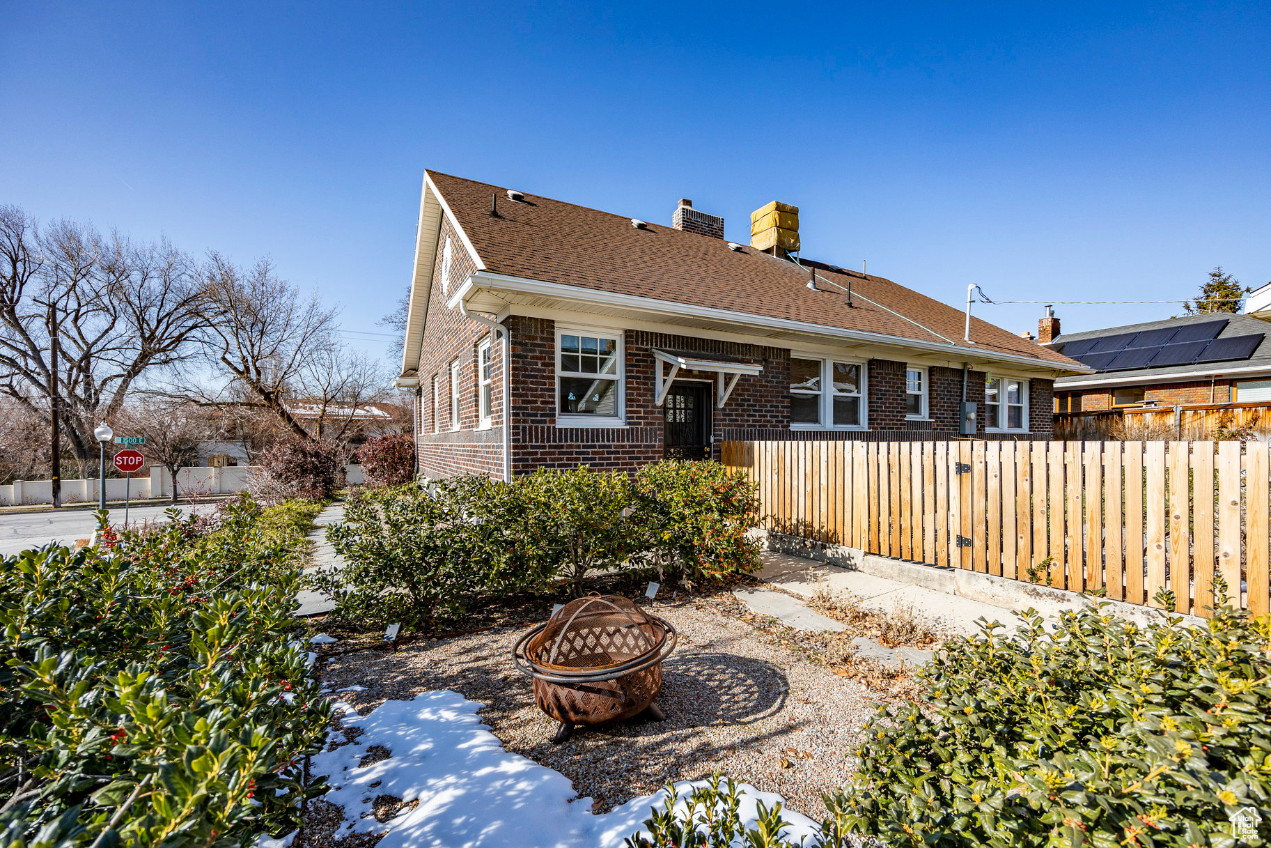 Back of property featuring a fire pit