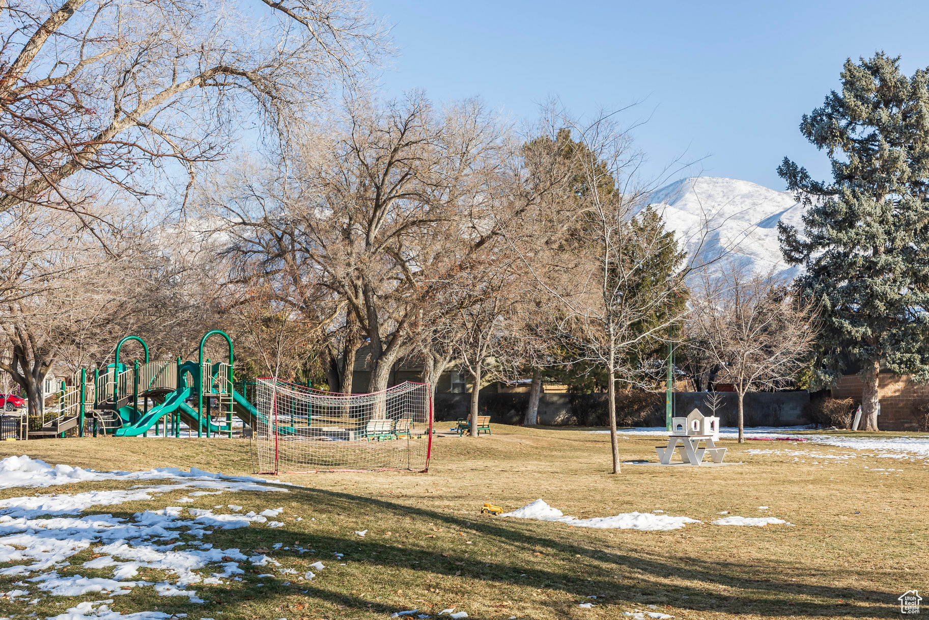 View of jungle gym with a lawn and a mountain view