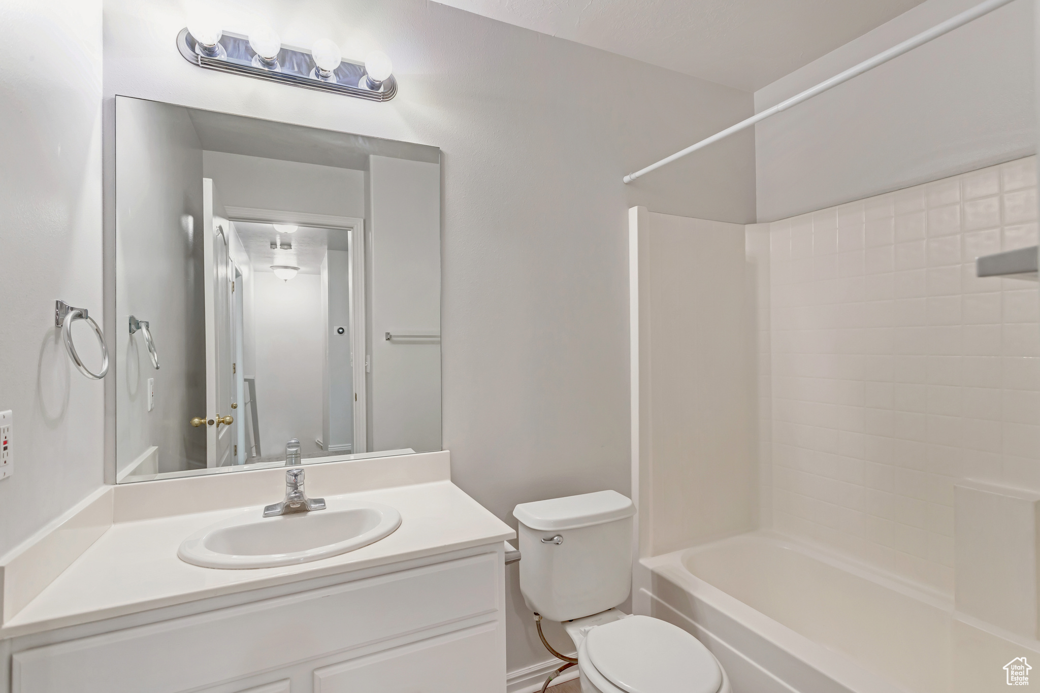 Full bathroom featuring toilet, vanity, and bathtub / shower combination