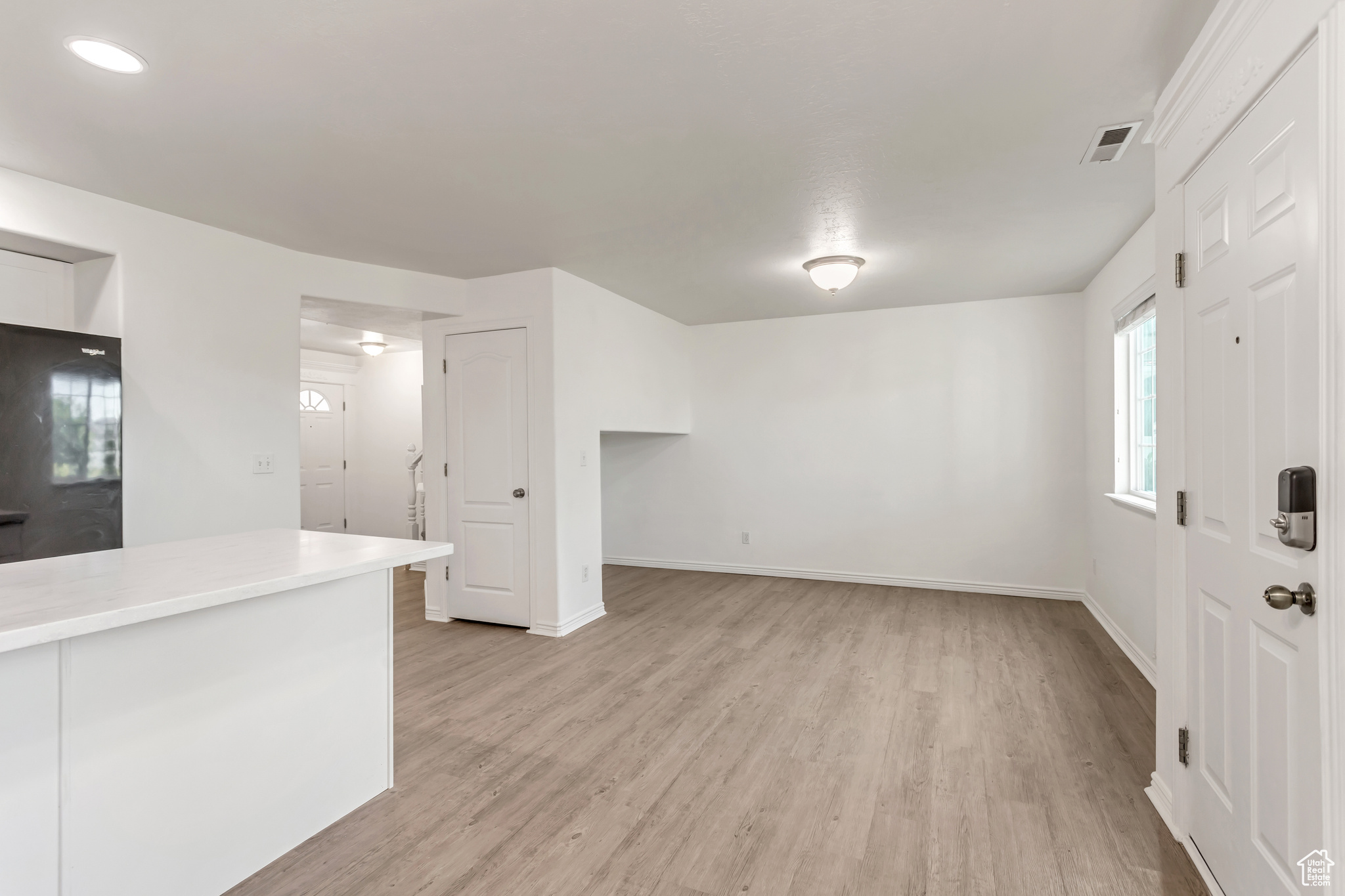 Unfurnished living room with light hardwood / wood-style floors