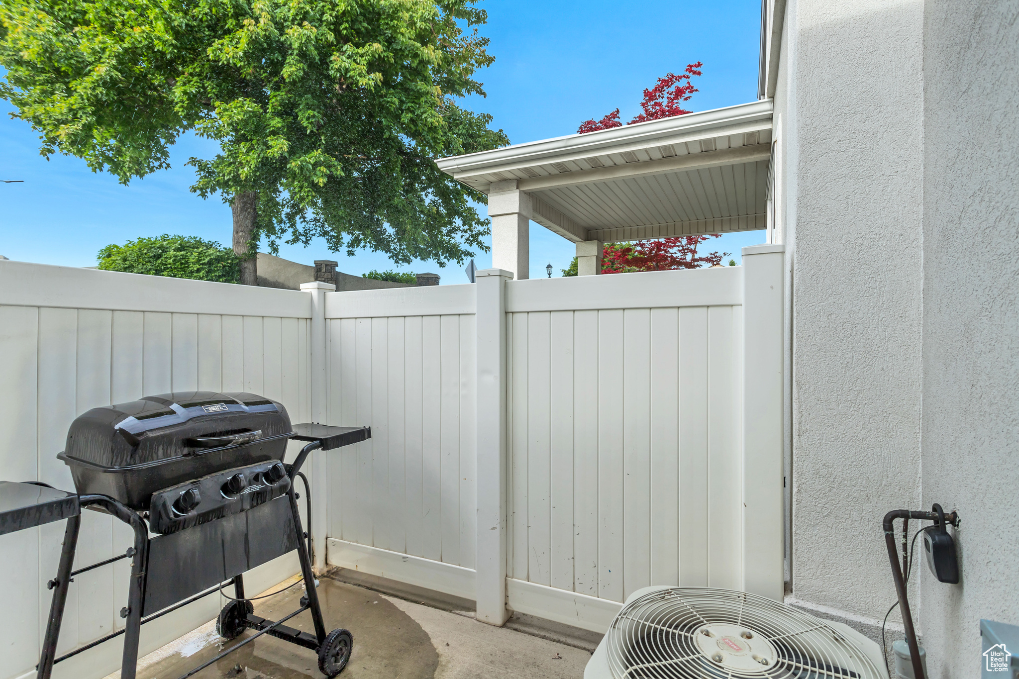 View of patio with area for grilling and central AC