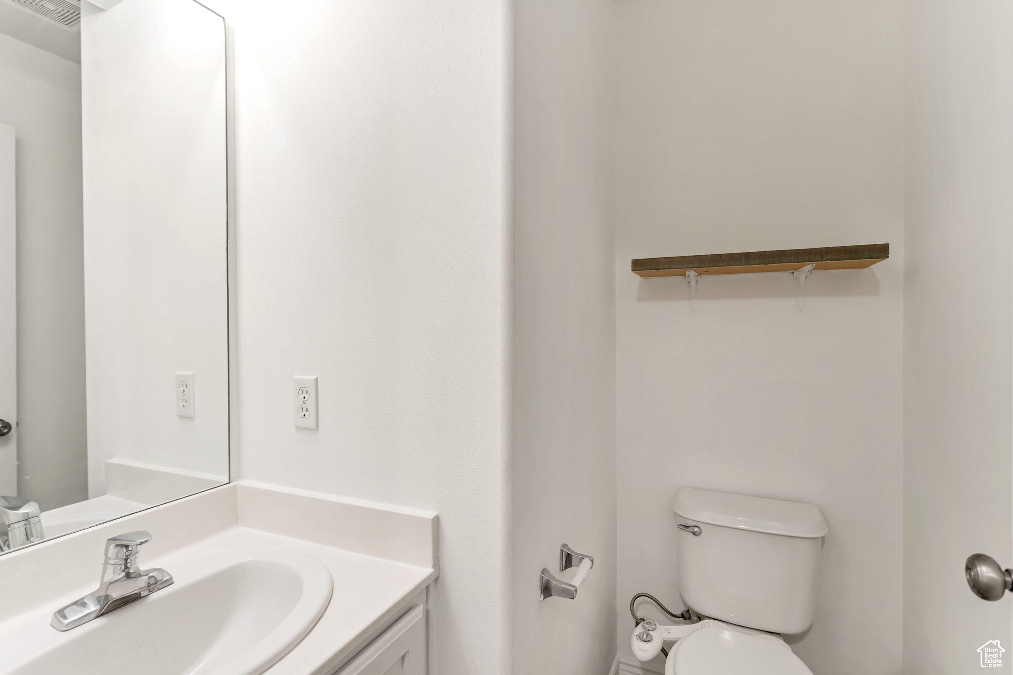 Main 1st Floor 1/2 Bathroom featuring toilet and vanity