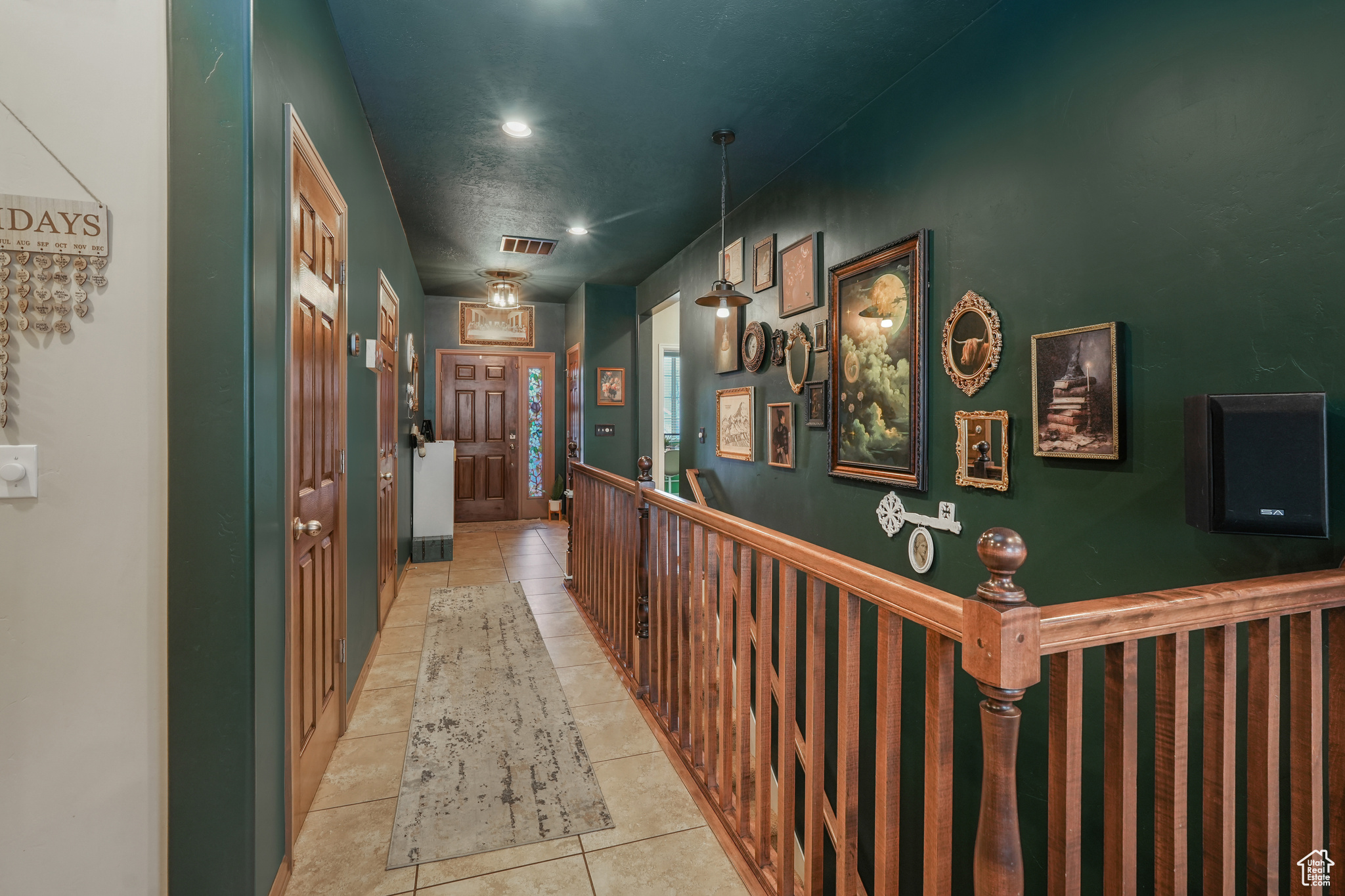 Corridor with a textured ceiling and light tile patterned floors