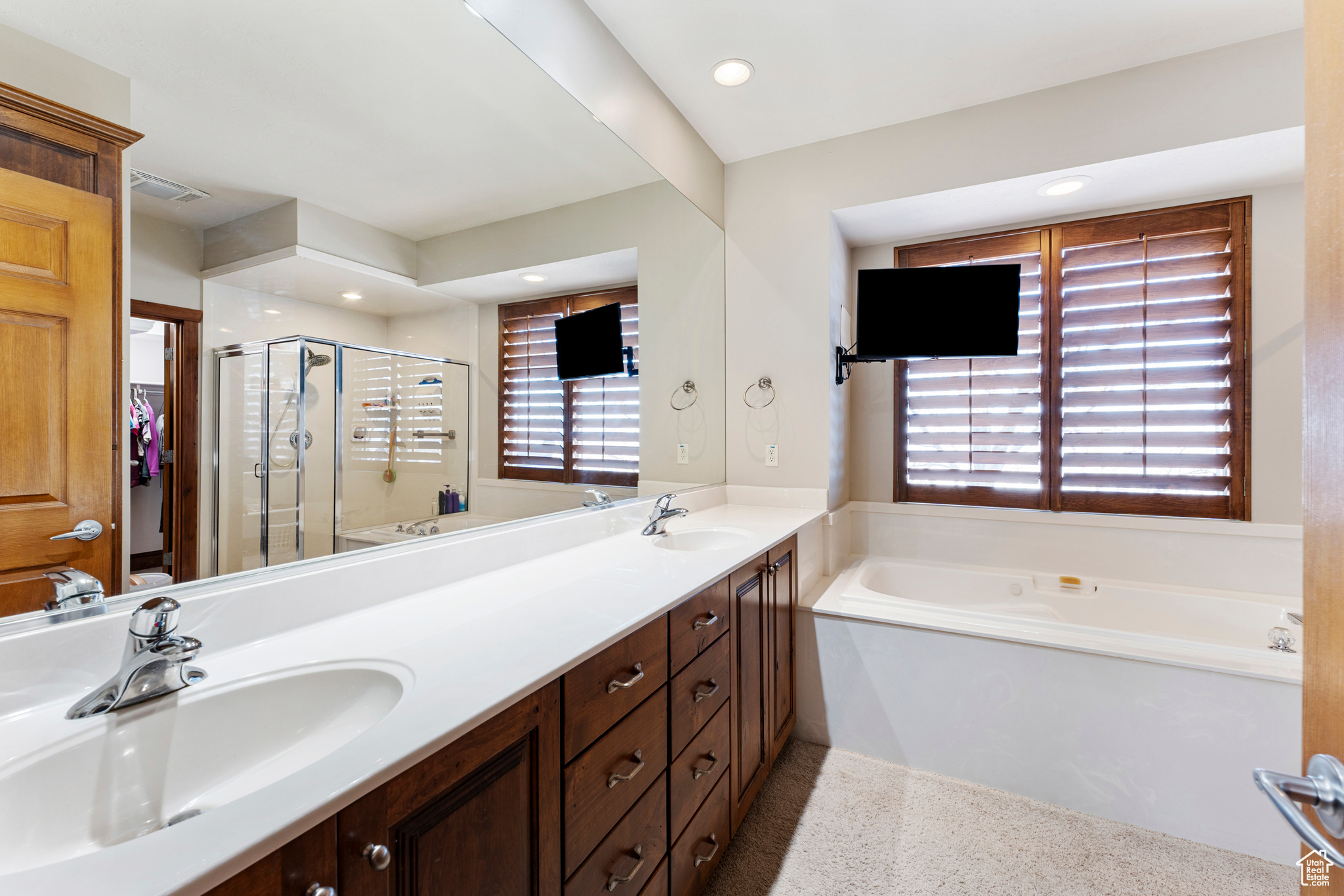 Bathroom featuring vanity and plus walk in shower