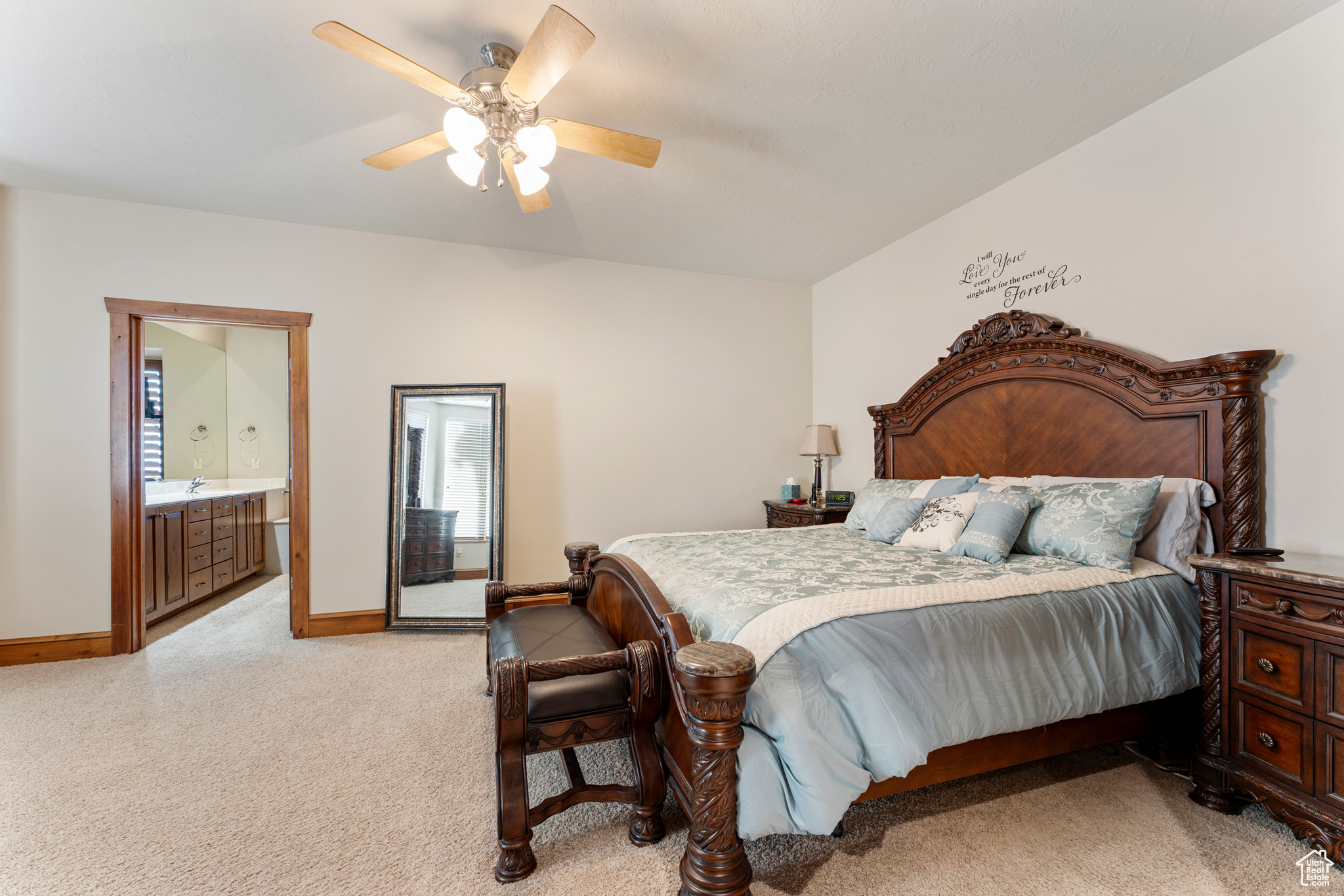 Bedroom featuring ensuite bathroom and ceiling fan