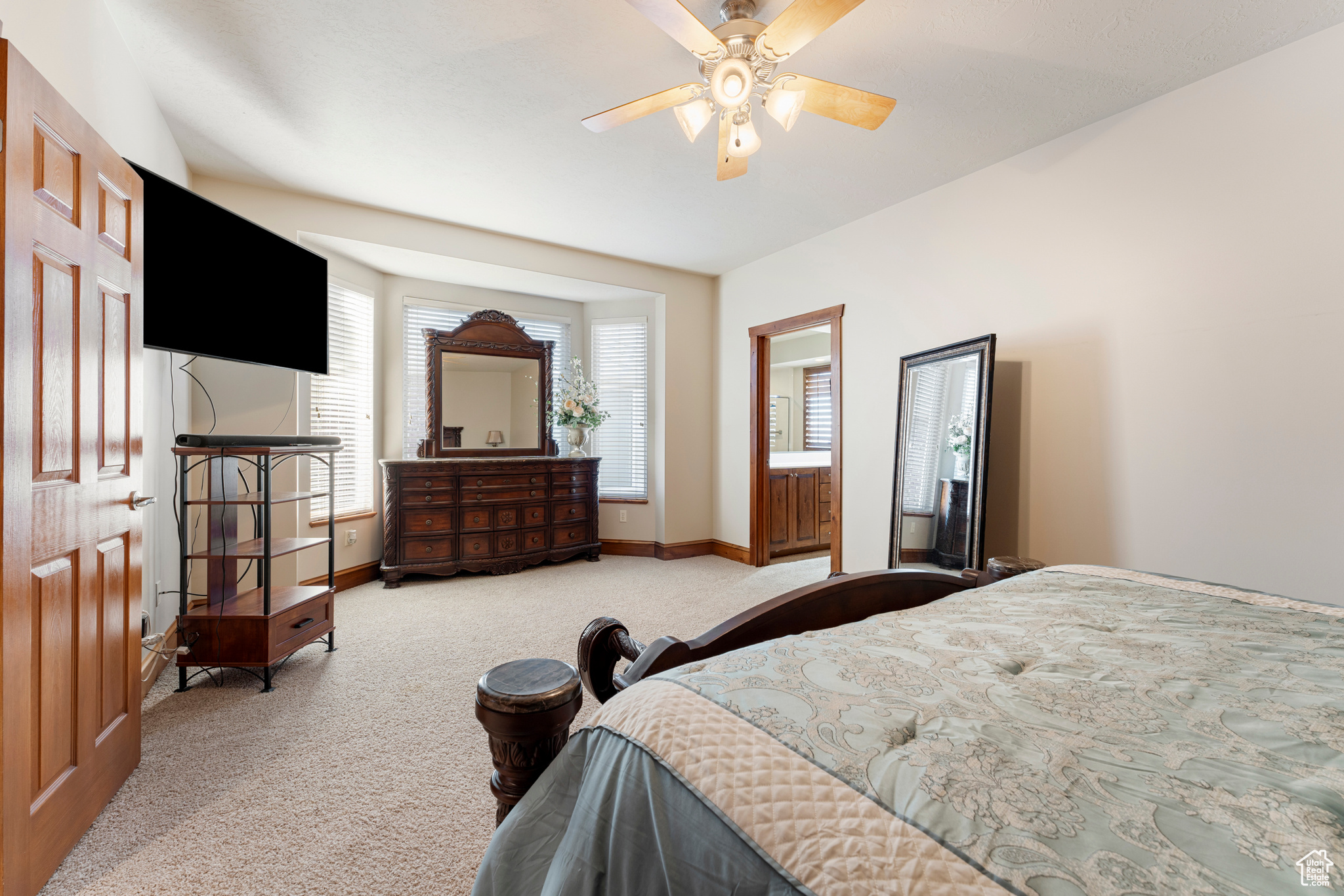 Bedroom featuring light colored carpet and ceiling fan