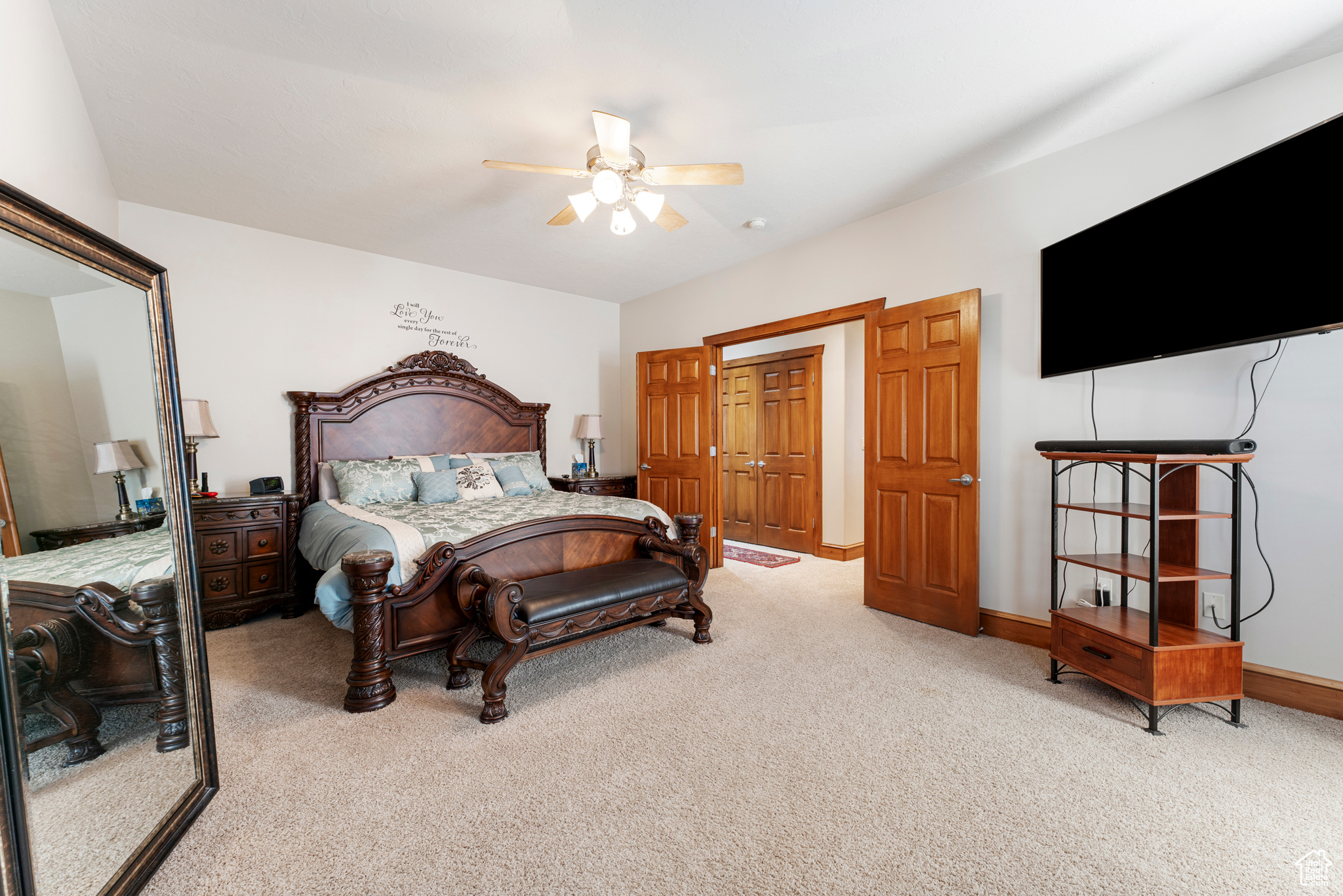 Bedroom with light colored carpet and ceiling fan