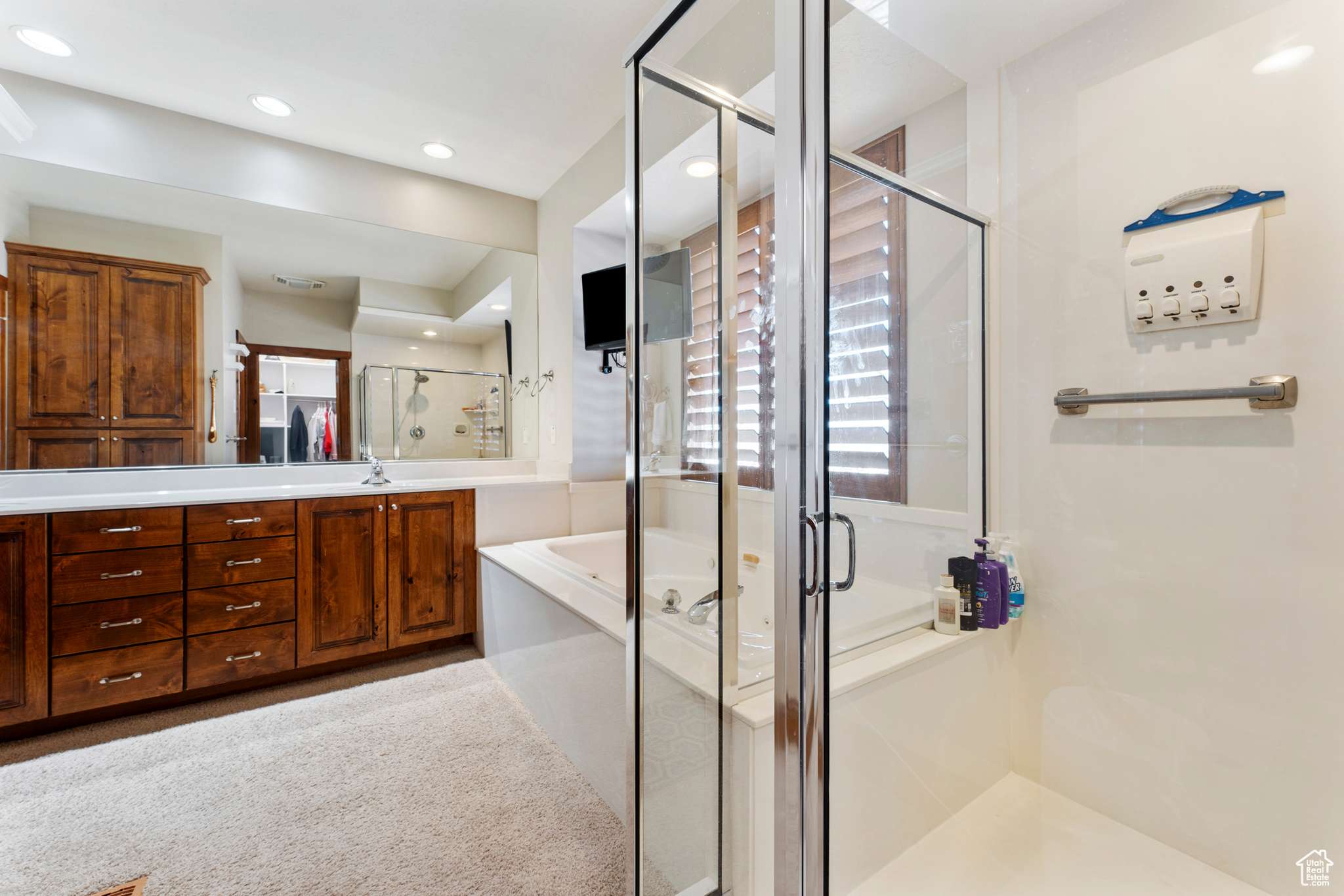 Bathroom featuring vanity and shower with separate bathtub