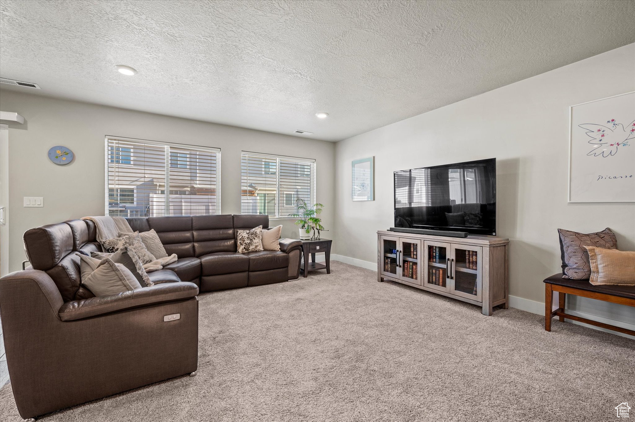 Living room featuring carpet floors and a textured ceiling