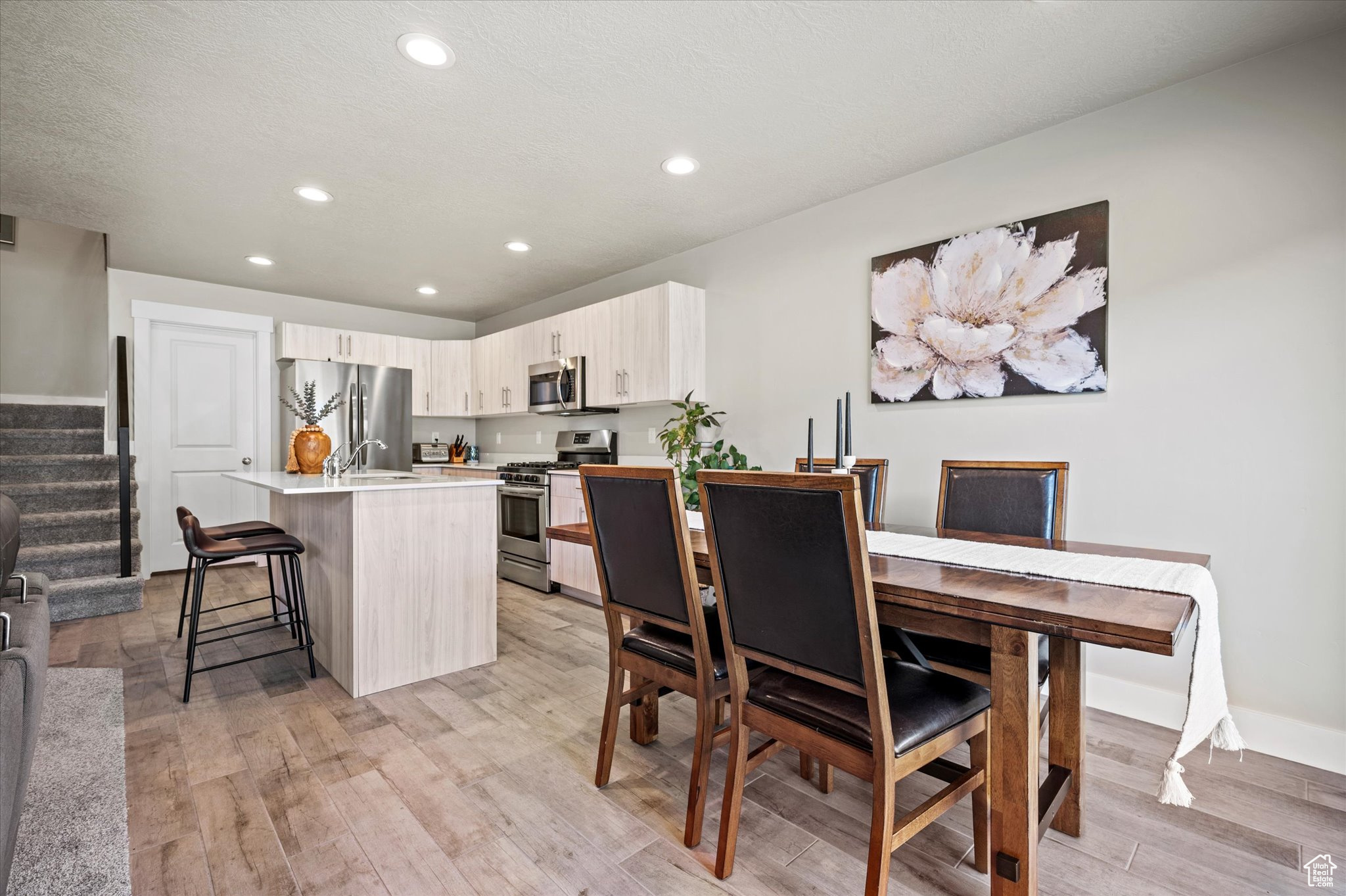 Dining area featuring sink and light wood-type flooring