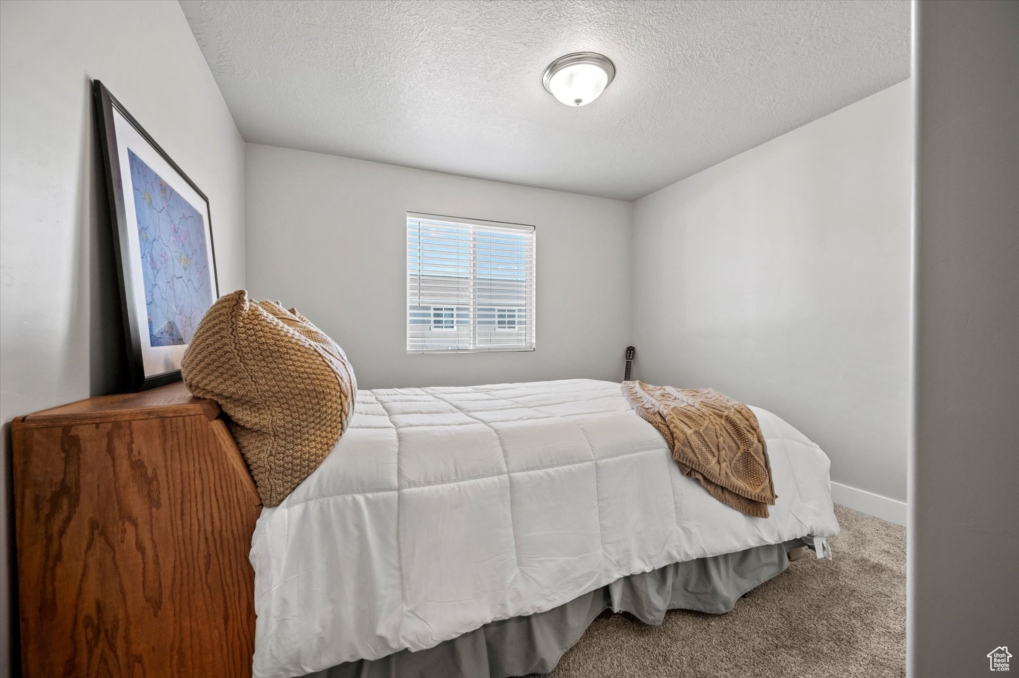 Carpeted bedroom with a textured ceiling