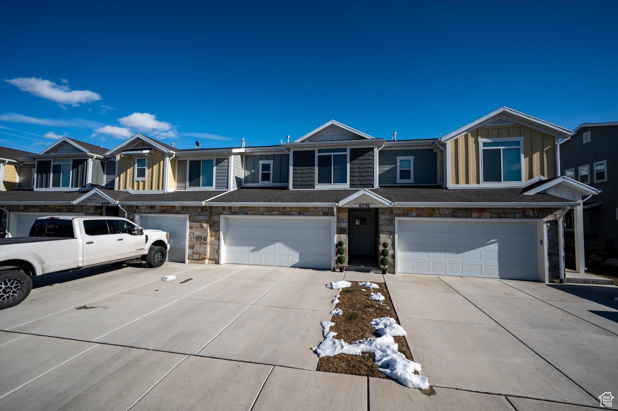 Townhome / multi-family property featuring a garage