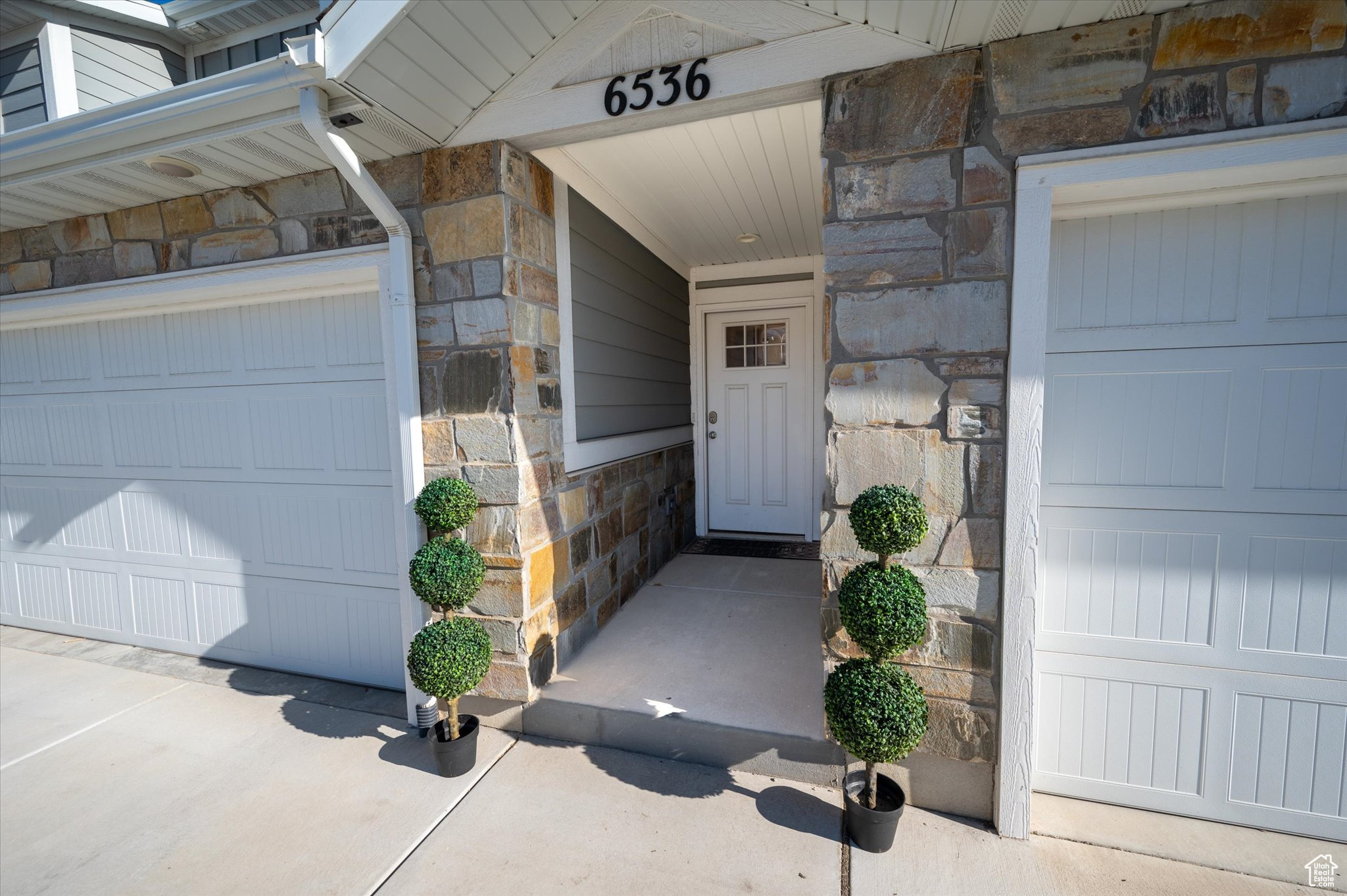 View of exterior entry with a garage