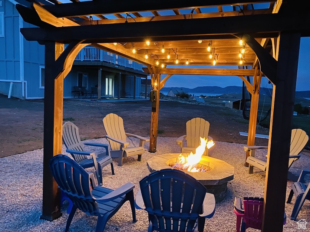 View of patio with a mountain view and a fire pit