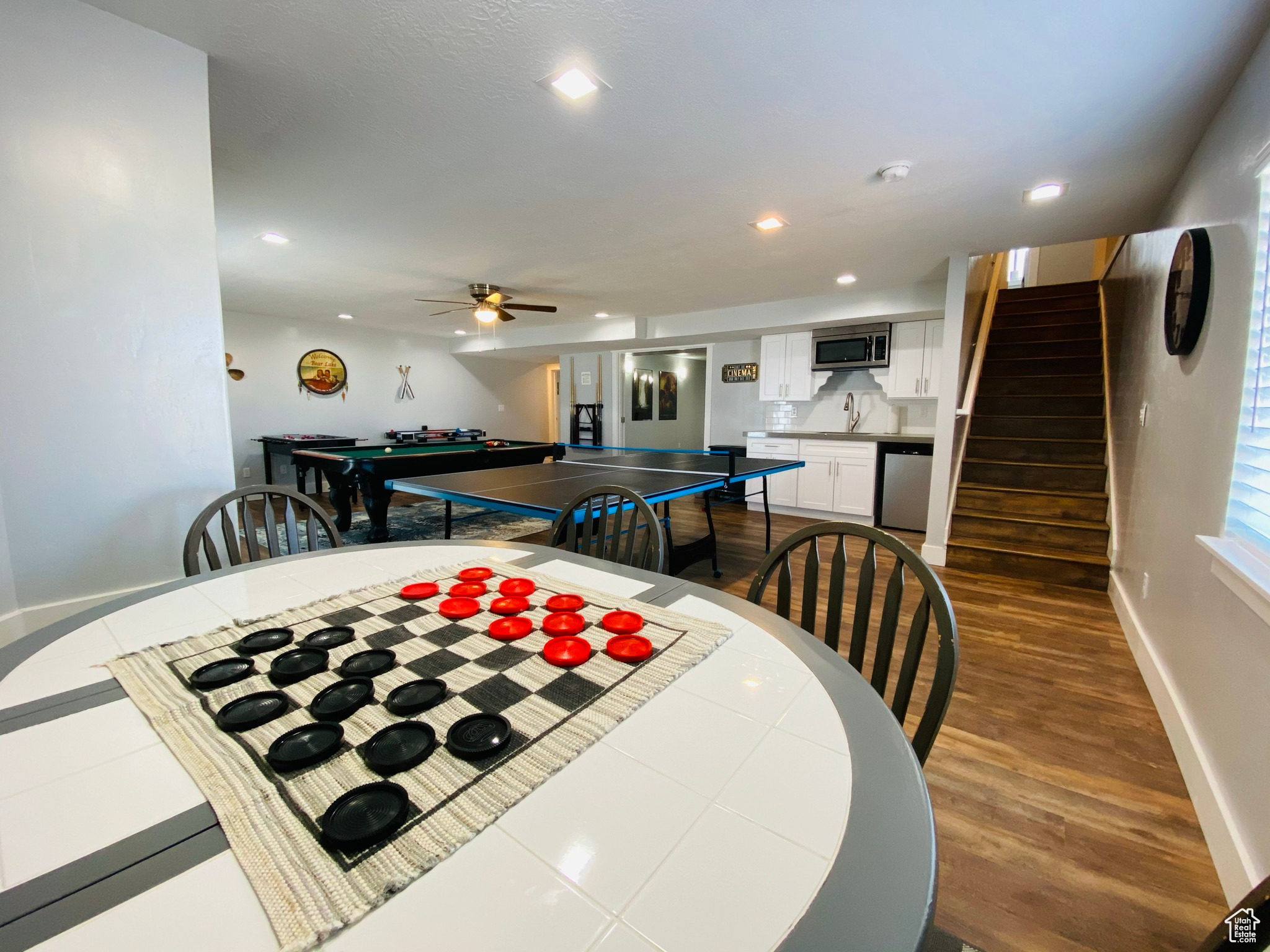 Dining space featuring ceiling fan, hardwood / wood-style flooring, and sink