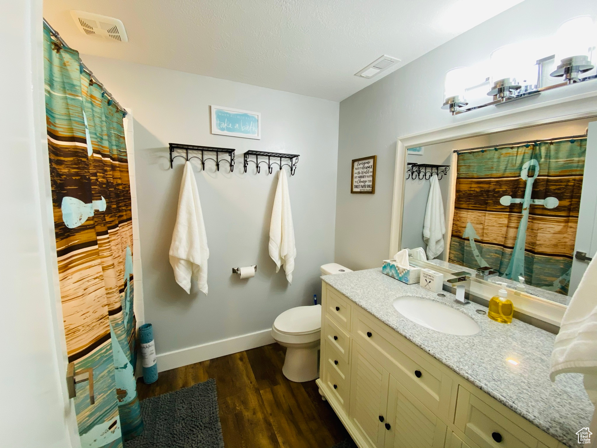 Bathroom with toilet, hardwood / wood-style flooring, and vanity