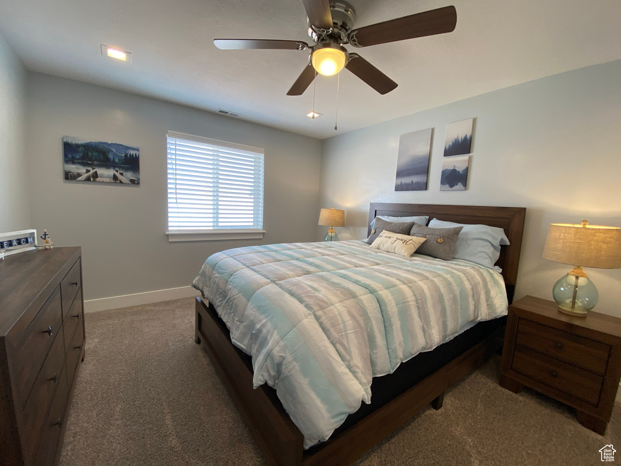 Carpeted bedroom with ceiling fan