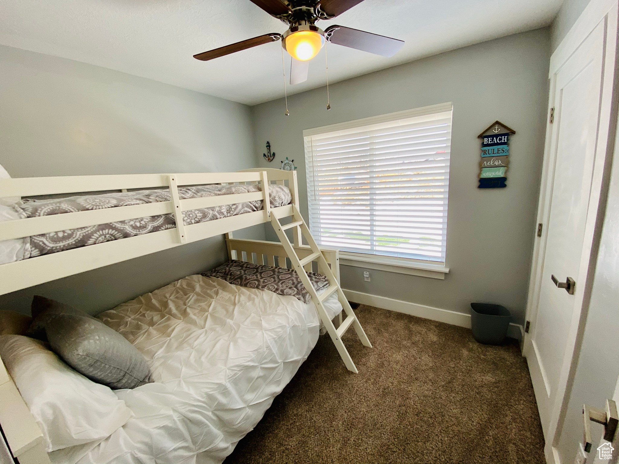 Bedroom featuring ceiling fan and carpet flooring