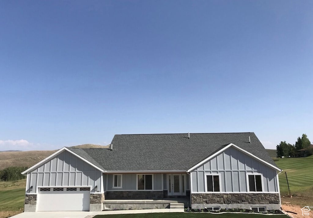 View of front of home featuring a garage and a front lawn