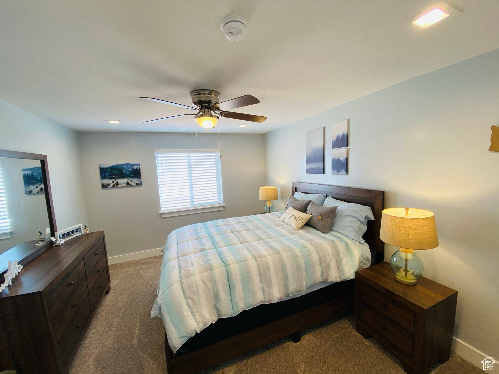 Carpeted bedroom featuring ceiling fan