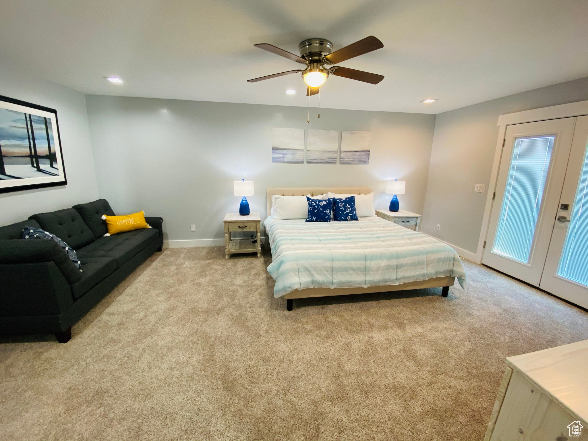 Carpeted bedroom featuring ceiling fan, french doors, and access to outside