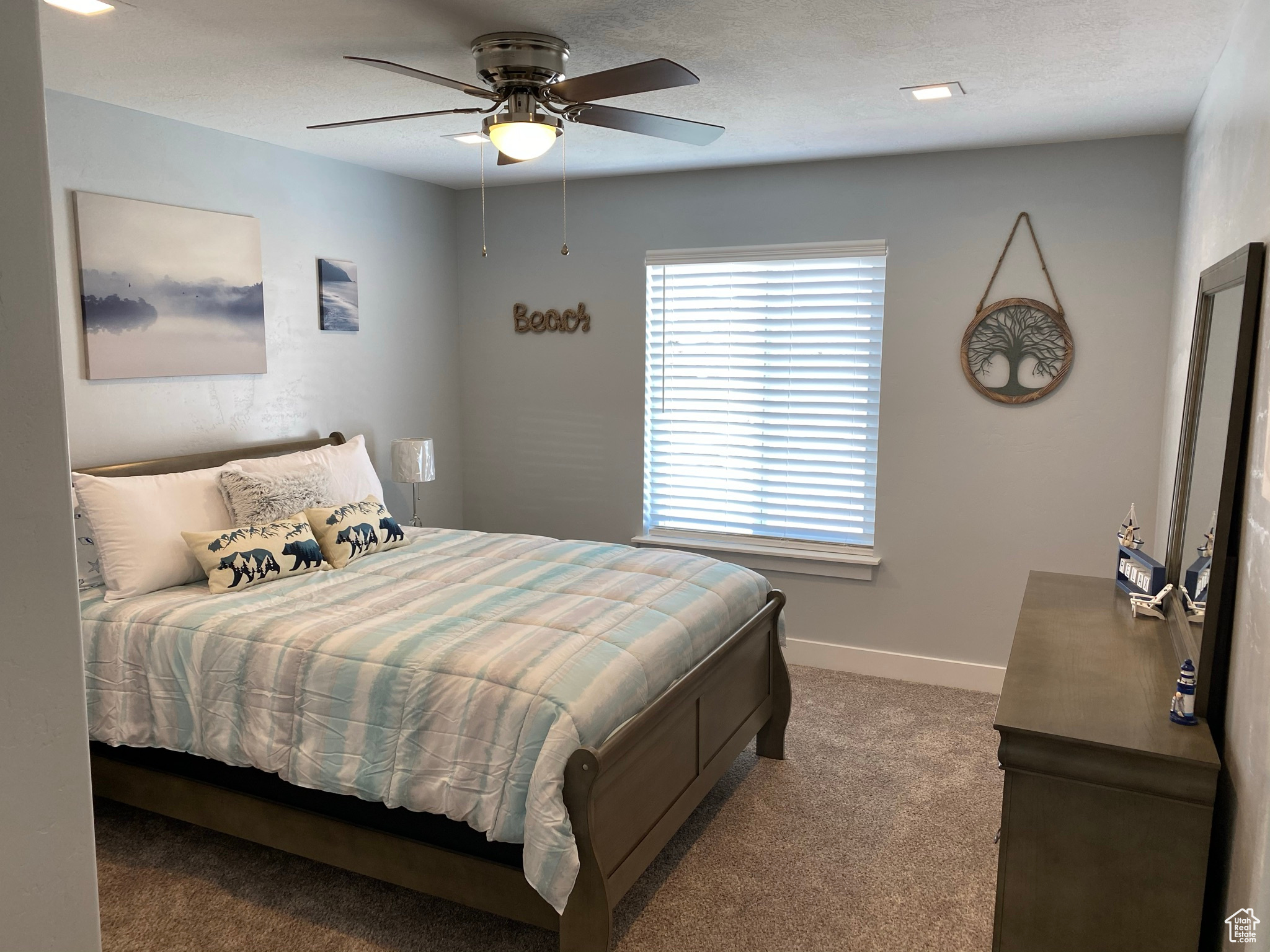 Carpeted bedroom featuring ceiling fan