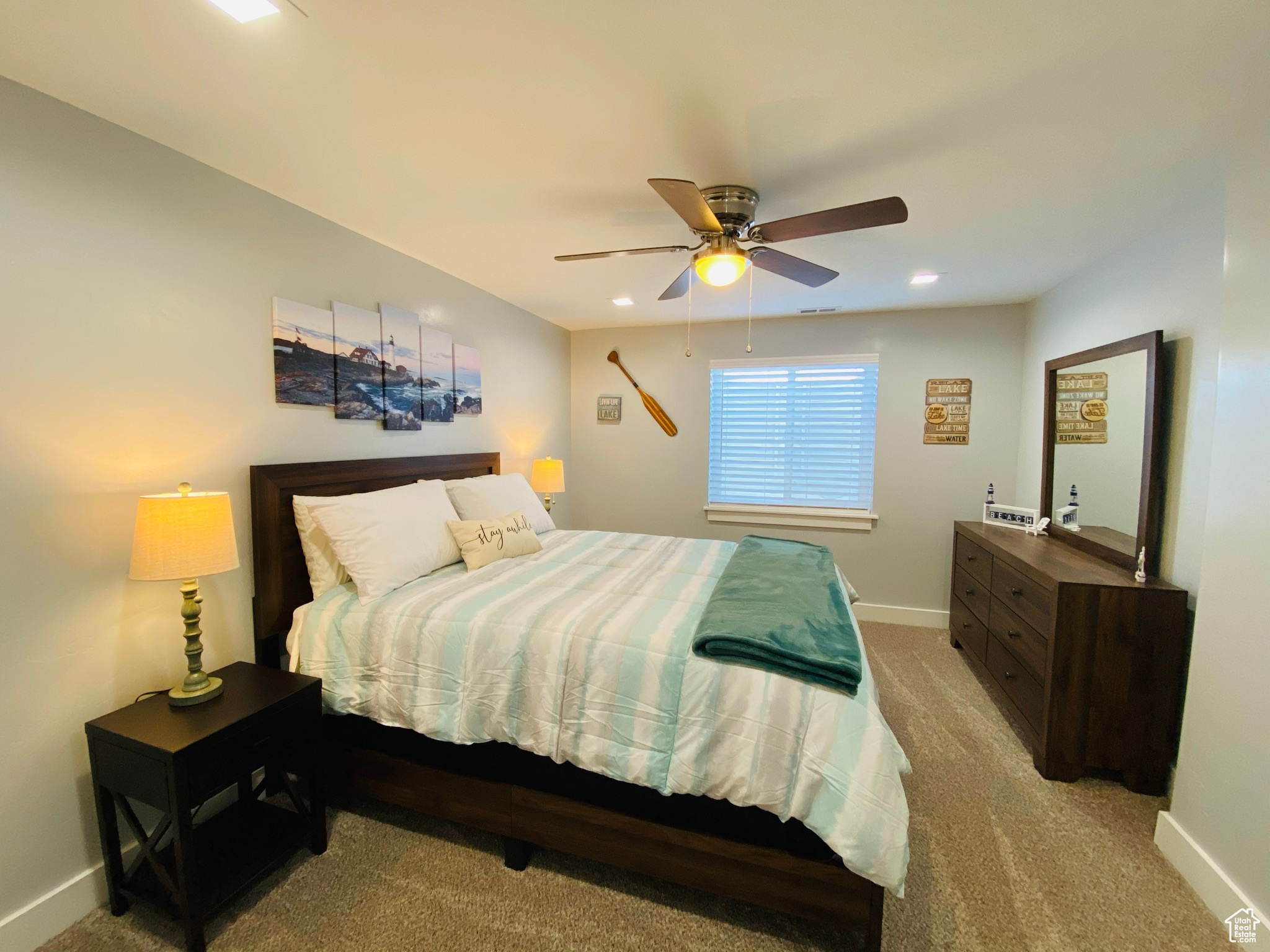 Carpeted bedroom with ceiling fan