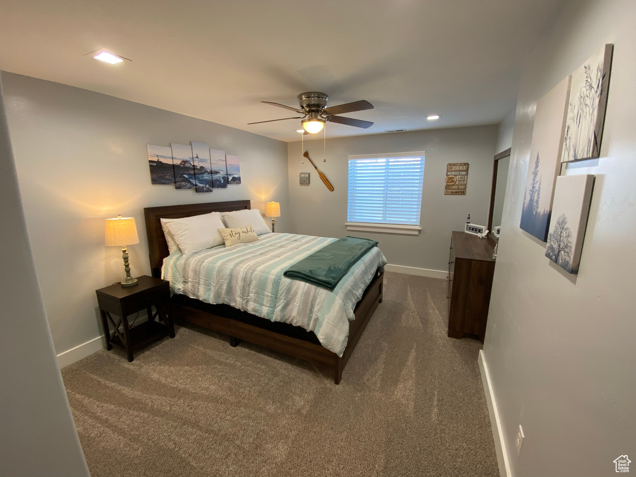 Carpeted bedroom featuring ceiling fan