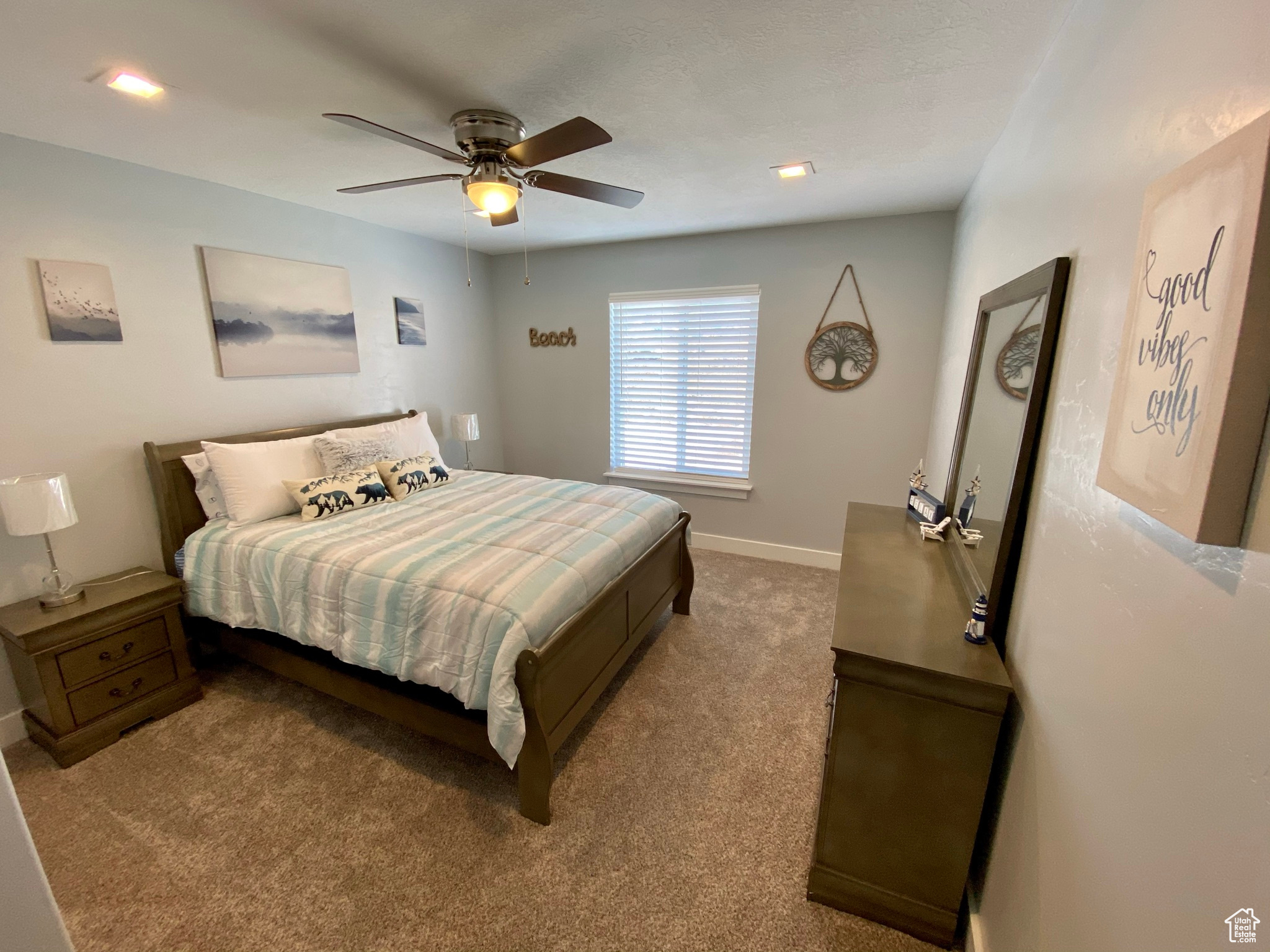 Carpeted bedroom featuring ceiling fan