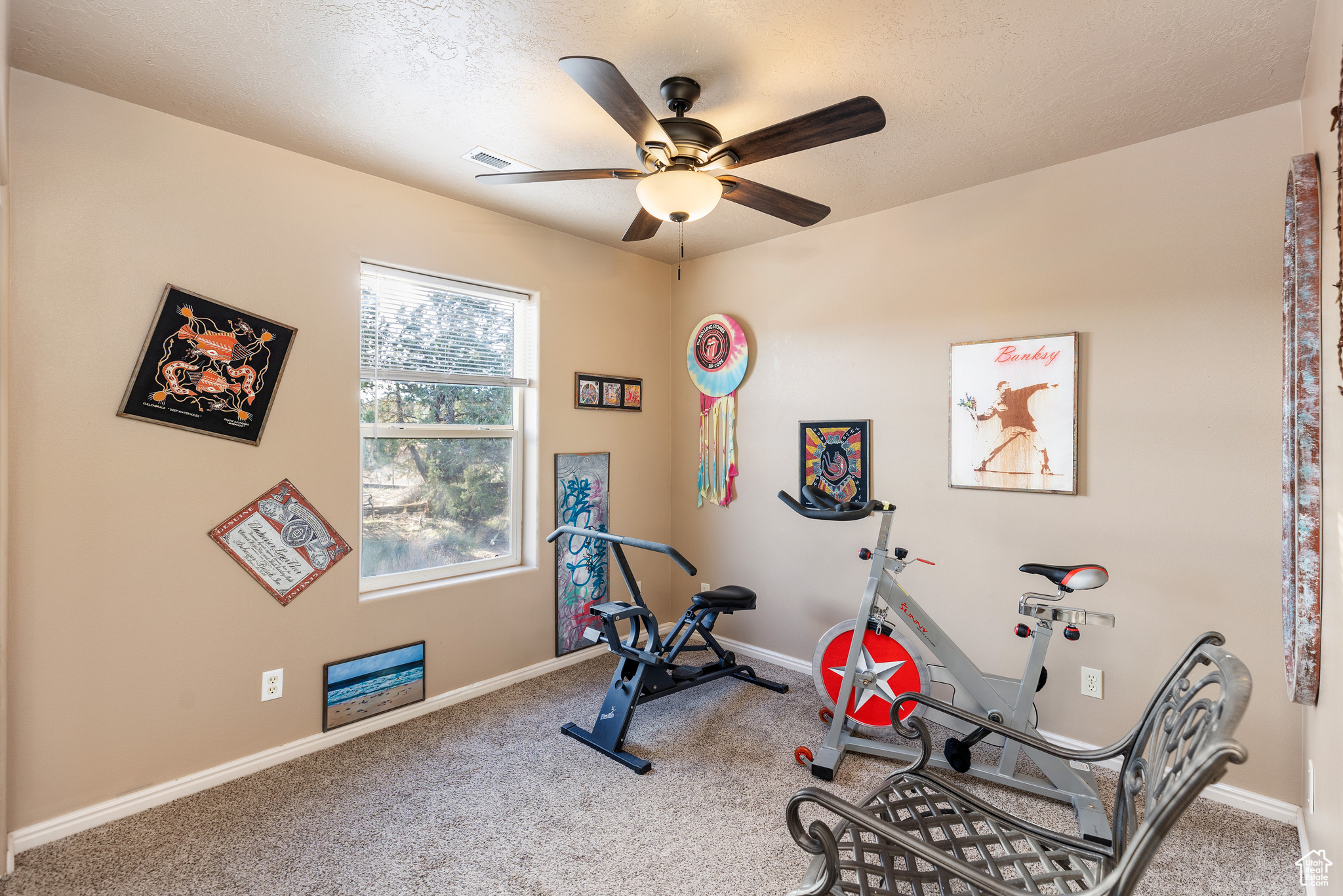 Exercise area with ceiling fan and carpet