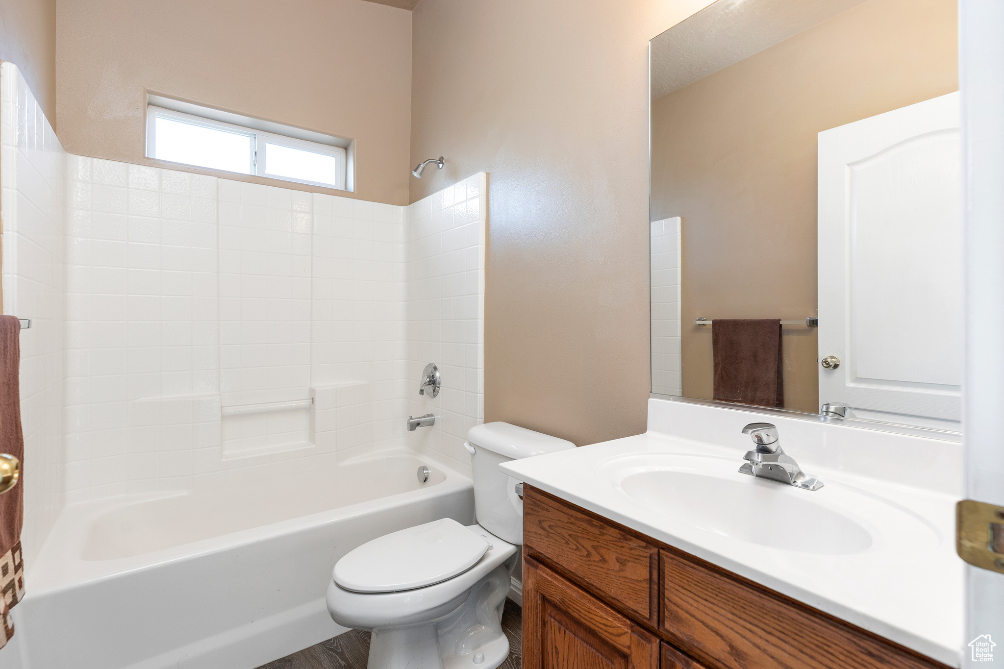 Full bathroom with toilet, vanity, and bathtub / shower combination